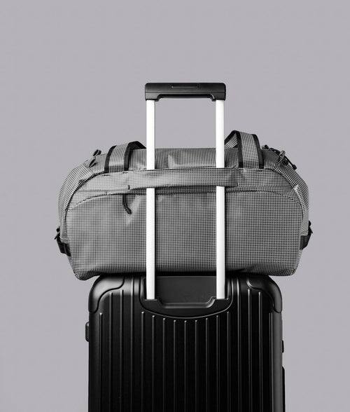 Alt View 1. ALPAKA - 35L Lightweight Duffel Bag for Gym, Weekend Trips & Carry-On Travel, Momentum Duffel, Weather-Resistant - Axodyne hybrid Grey.