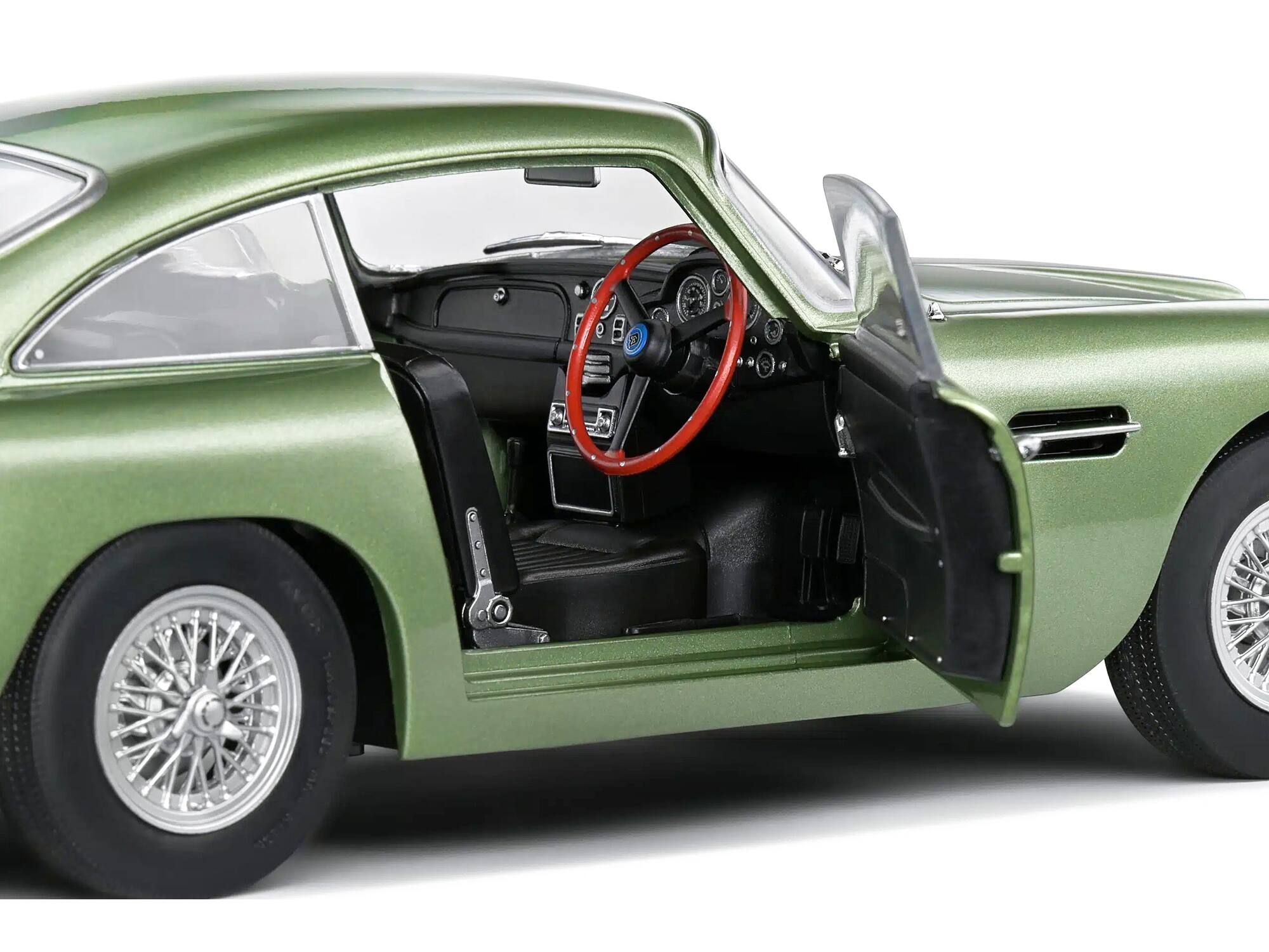 Left. Solido - 1964 Aston Martin DB5 RHD (Right Hand Drive) Porcelain Green Metallic 1/18 Diecast Model Car by Solido - Green Metallic.