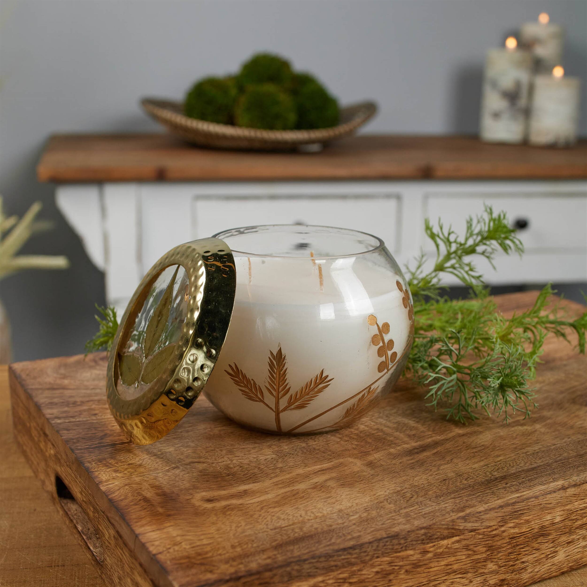 Angle. BreeBe - Frosted Juniper Scented Soy Candle with Pressed Leaf Lid 5"D - White, Gold.