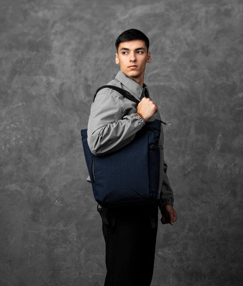 Left. ALPAKA - Flow Totepack Laptop Backpack for Men, 16" Laptop Compartment + 11" Tablet Sleeve, Tote/Backpack, Bottle Pocket - Moonlight Blue Axoflux 400D Washed Nylon.