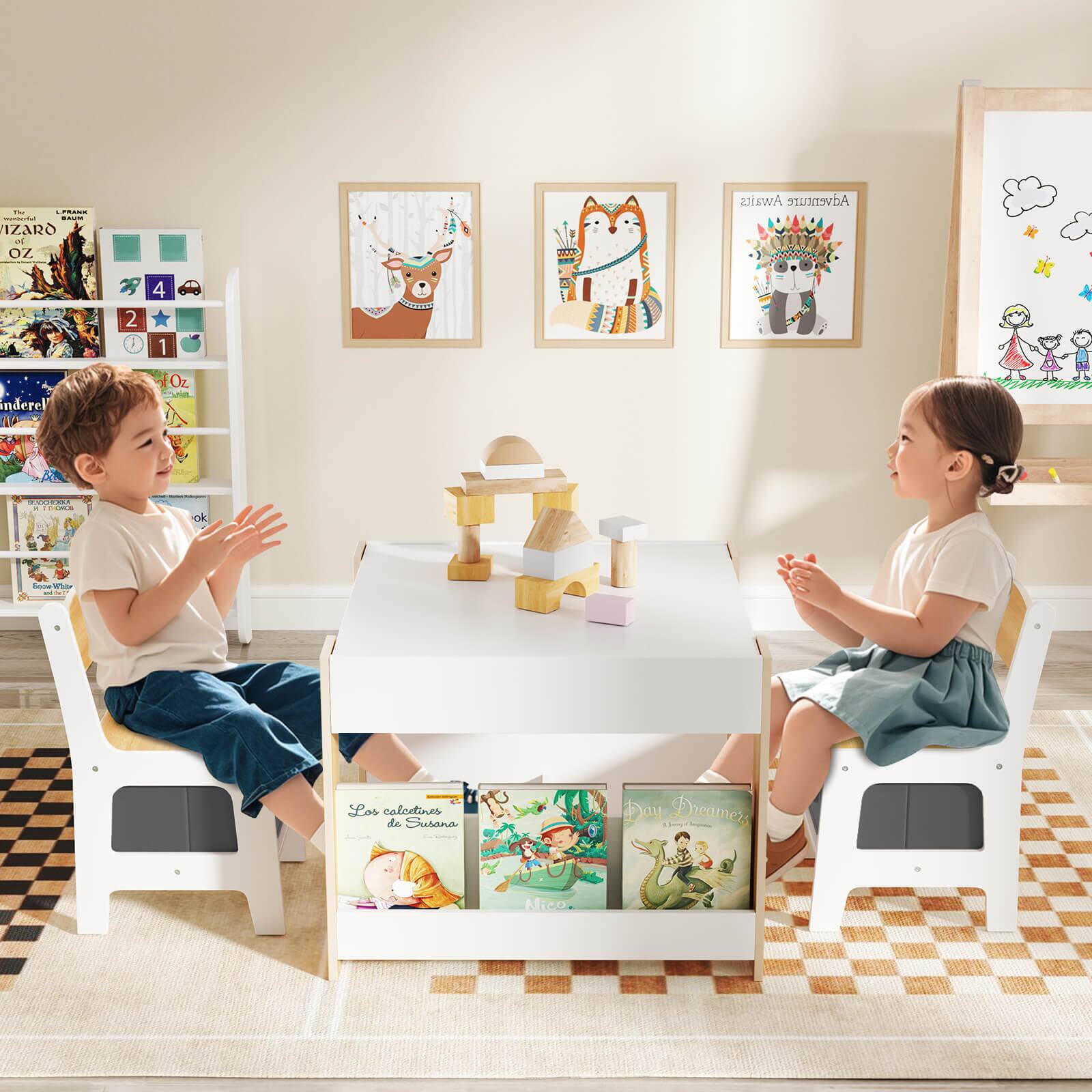 The image shows two children sitting at a table, which is covered with books. The books are arranged in a way that they are placed on the table, and some of them are stacked on the floor. The children are engaged in a conversation, possibly discussing the books or sharing their thoughts and ideas. The scene suggests a cozy and comfortable environment, where the children can enjoy reading and learning together.
