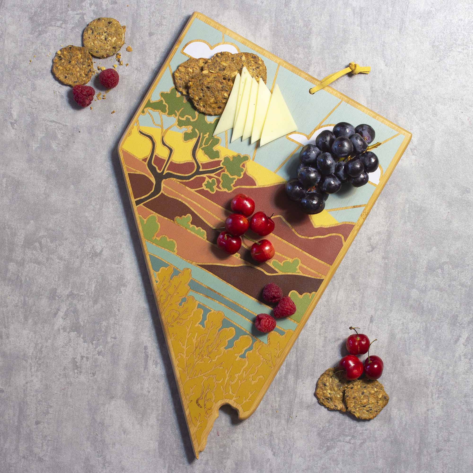 Angle. Totally Bamboo - Nevada Cutting Board with Artwork by Summer Stokes.