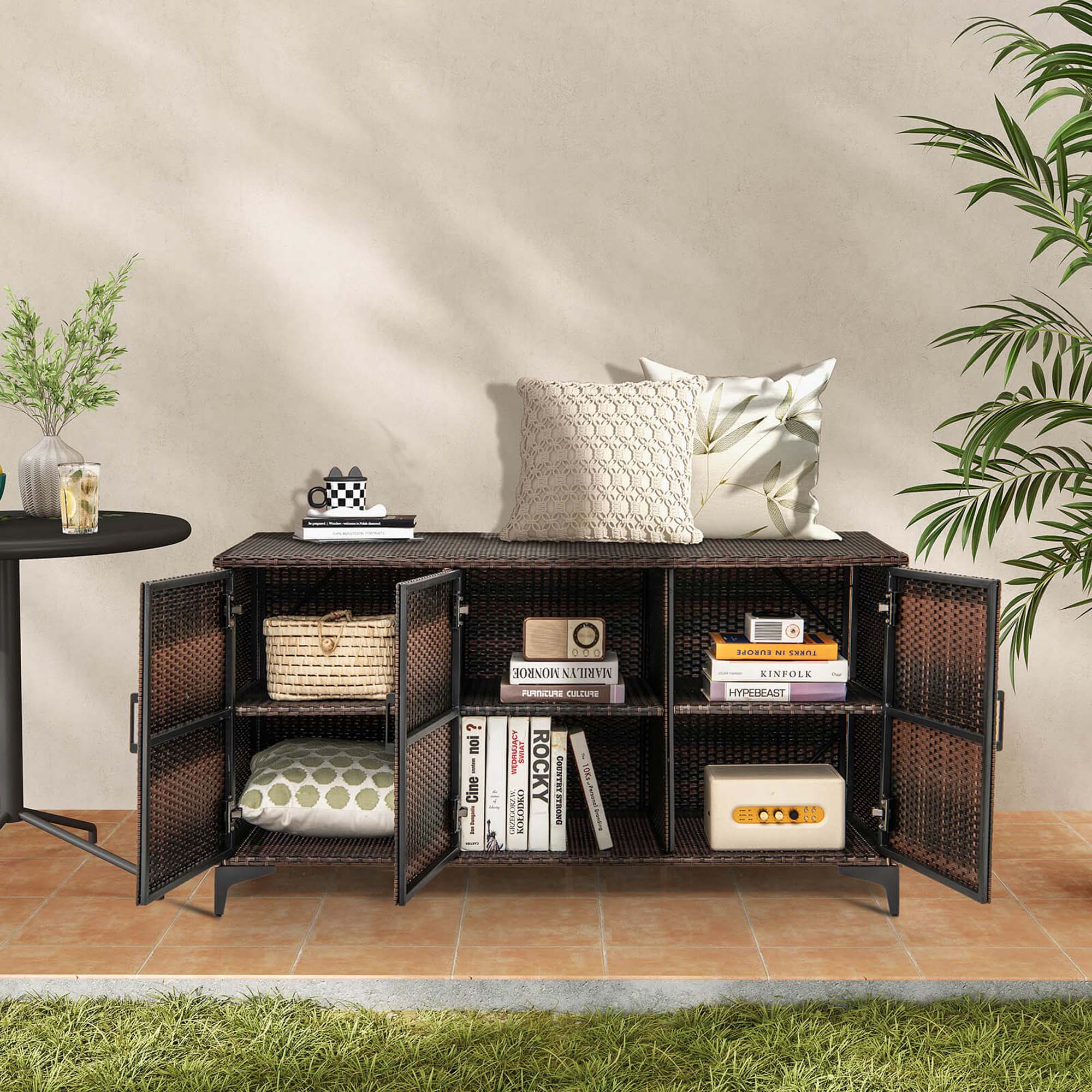 The image features a black shelf with a variety of items on it. There are several books arranged on the shelf, as well as a cup and a vase. Additionally, there is a potted plant nearby, adding a touch of greenery to the scene. The shelf is placed in front of a wall, creating a visually appealing display.