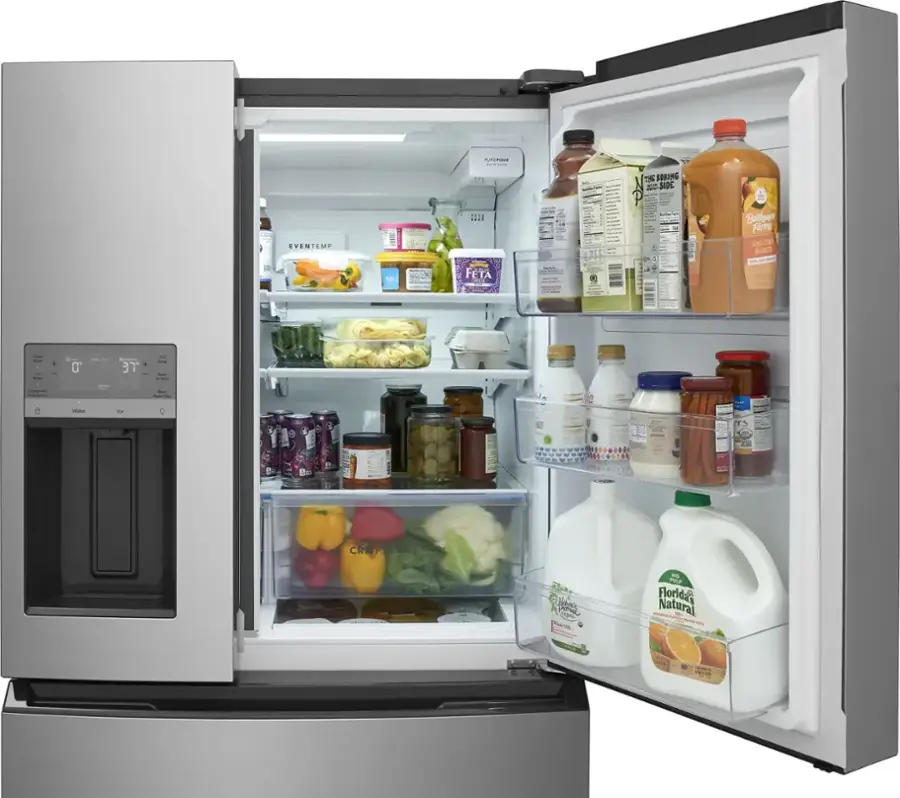 The refrigerator is stocked with a variety of food and drinks. The shelves are filled with items such as milk, juice, and vegetables. There are also several bottles of condiments and beverages, including a bottle of orange juice. The refrigerator is well-organized, with the food items placed neatly in the compartments. The refrigerator is open, revealing the contents inside.