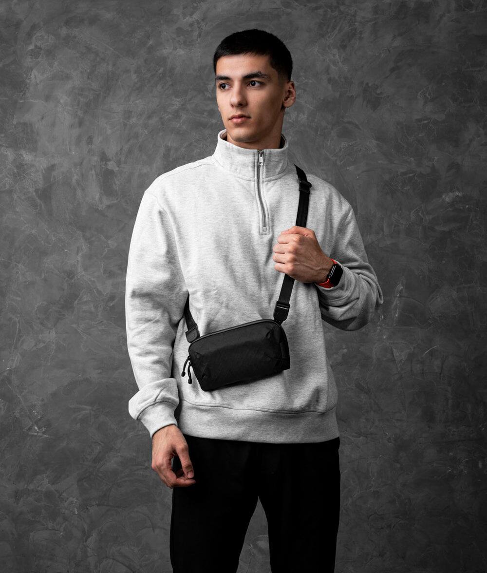 Angle. ALPAKA - Flight Pouch Pro Travel Clutch Phone Bag, RFID Passport Holder Crossbody Pouch, Wristlet, YKK AquaGuard - Black Ultradyne 100D.