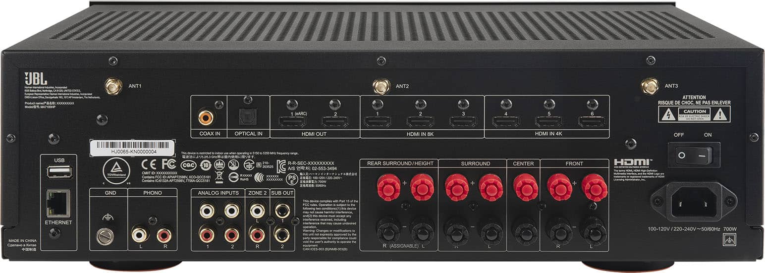 The image features a black electronic device with a row of red knobs on the front. The device has a variety of ports and connections, including HDMI in and out, USB, Ethernet, and analog inputs. The device is made in China and has a power rating of 700W. The image also contains a warning to be cautious when handling the device, as there is a risk of electric shock.