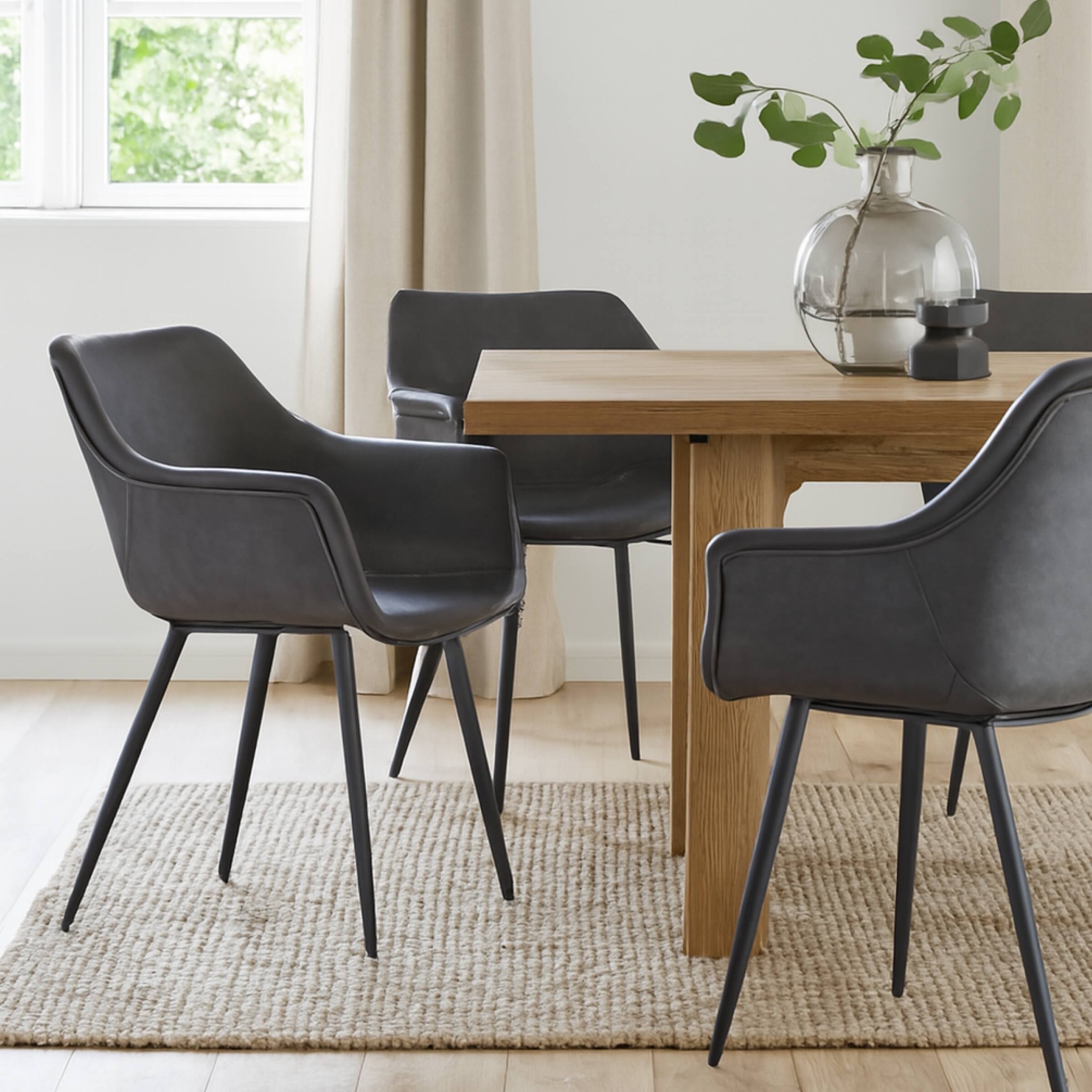 Angle. LeisureMod - Markley 2-PCS Modern Leather Accent Dining Chair with Powder-Coated Iron Legs - Charcoal Black.