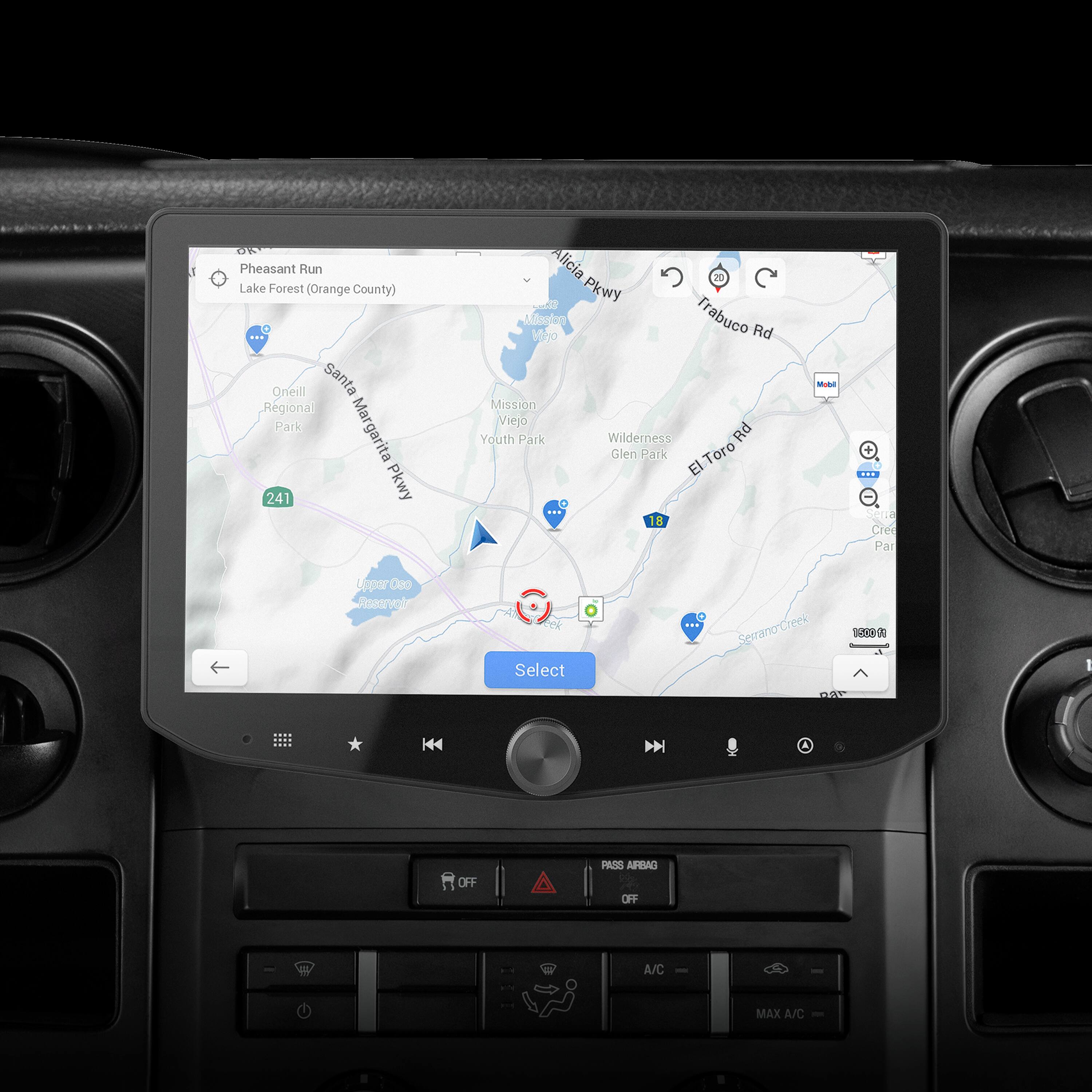 The image shows a car dashboard with a GPS screen displaying a map of the area. The map shows various locations, including Pheasant Run, Lake Forest, Santa Ana Regional Park, Margarita, Alicia Parkway, and Trabuco Road. The GPS screen also has a "select" button, which allows the user to choose their desired route or destination. The dashboard also features a radio and a temperature gauge, providing additional information for the driver.
