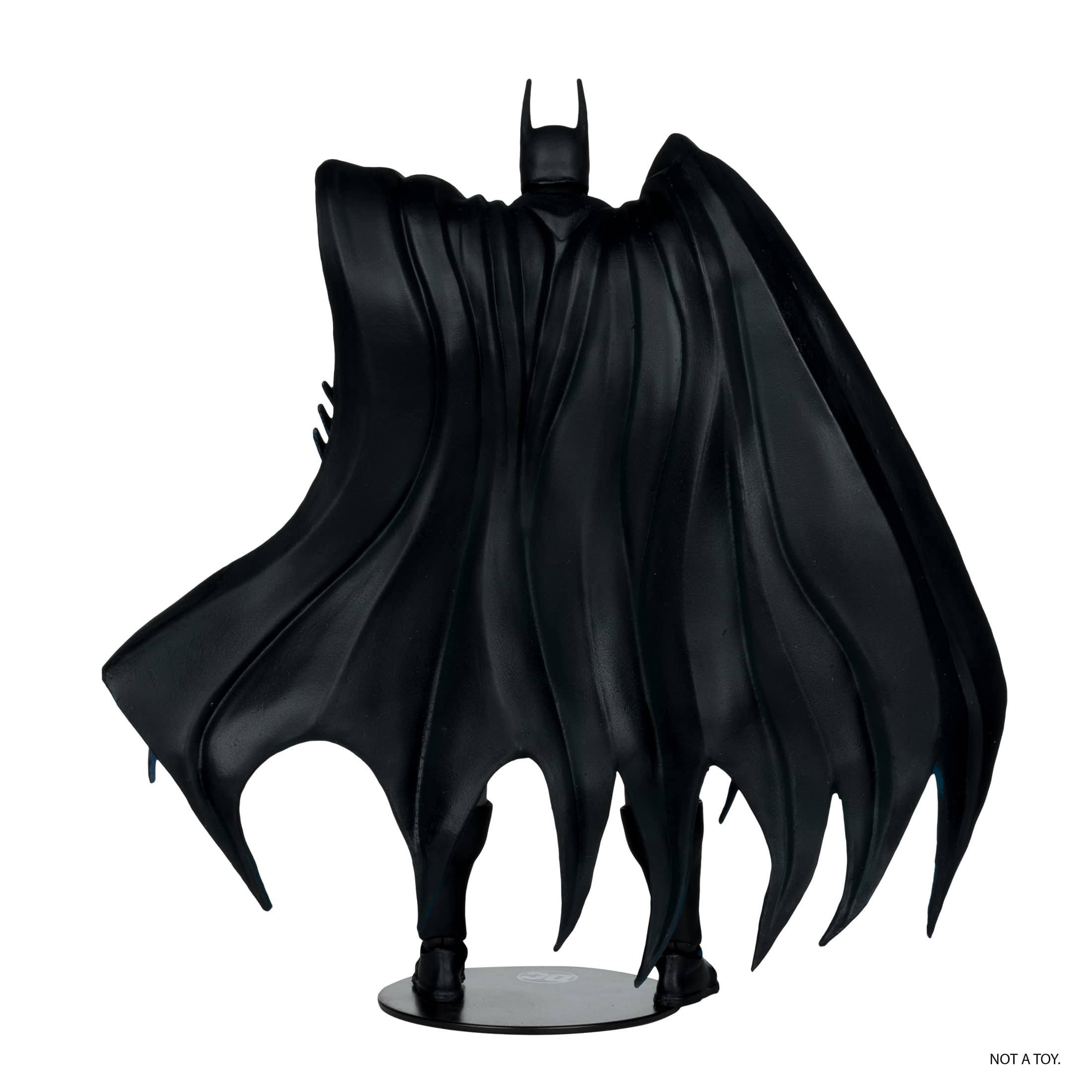 The image features a black Batman figurine, which is not a toy. It is a detailed and intricate representation of the popular superhero character. The figurine is displayed on a white background, which further emphasizes its artistic and non-toy nature.