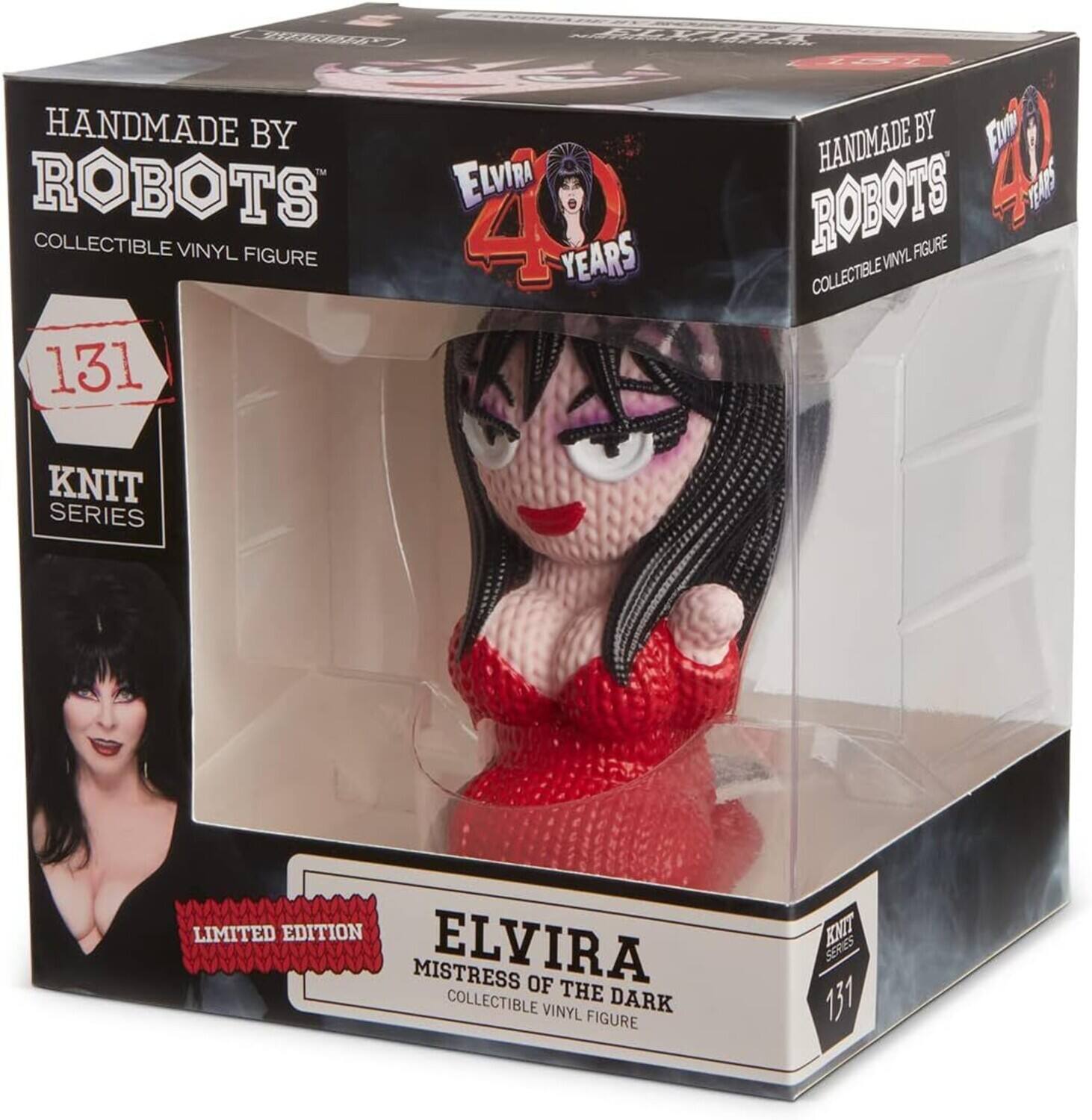 The text on the image can be grouped and corrected as follows:

- Handmade by Robots
- Collectible Vinyl Figure
- Elvira
- 40 Years
- Knit Series
- Limited Edition
- Mistress of the Dark
- 131

The corrected text from the image is:

"Handmade by Robots Elvira Collectible Vinyl Figure 40 Years Knit Series Limited Edition Mistress of the Dark 131"