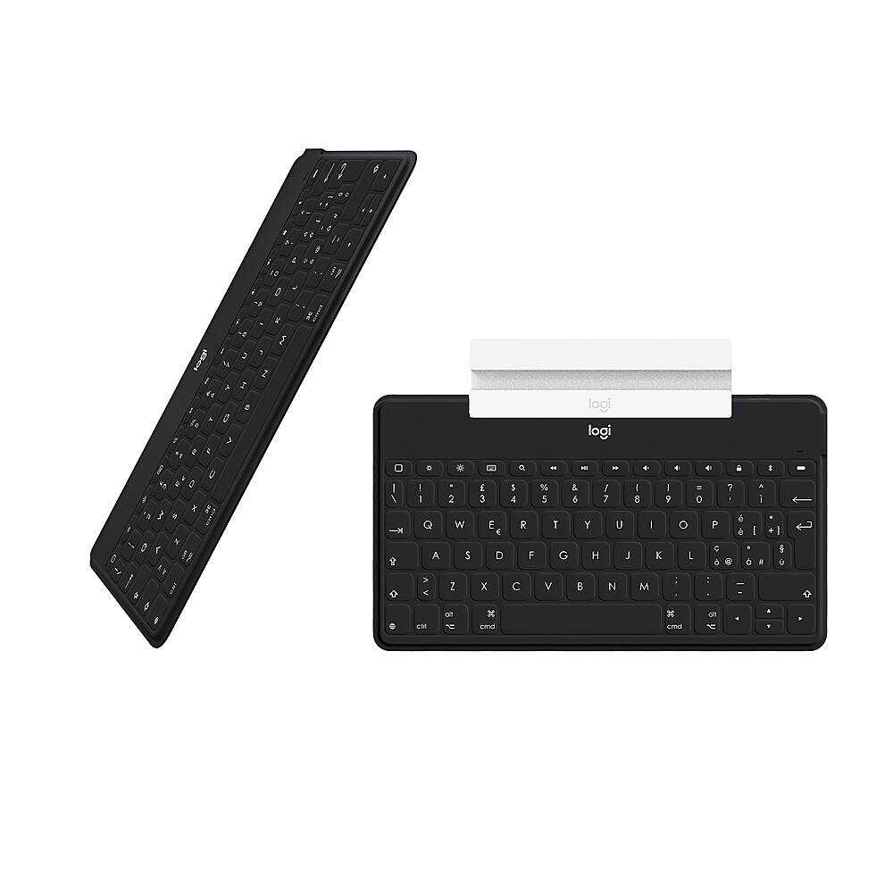 The image features a black keyboard and a white keyboard, both sitting on a white background. The black keyboard is placed on top of the white keyboard. The text on the image reads "logi - - - . + - % & / I I - 5 6 7 8 9 0 T Y U - o P E G H J K 1 6 : : V B N M d x en cmdd a 7 A I d a I - .  .  1  a -  t ."