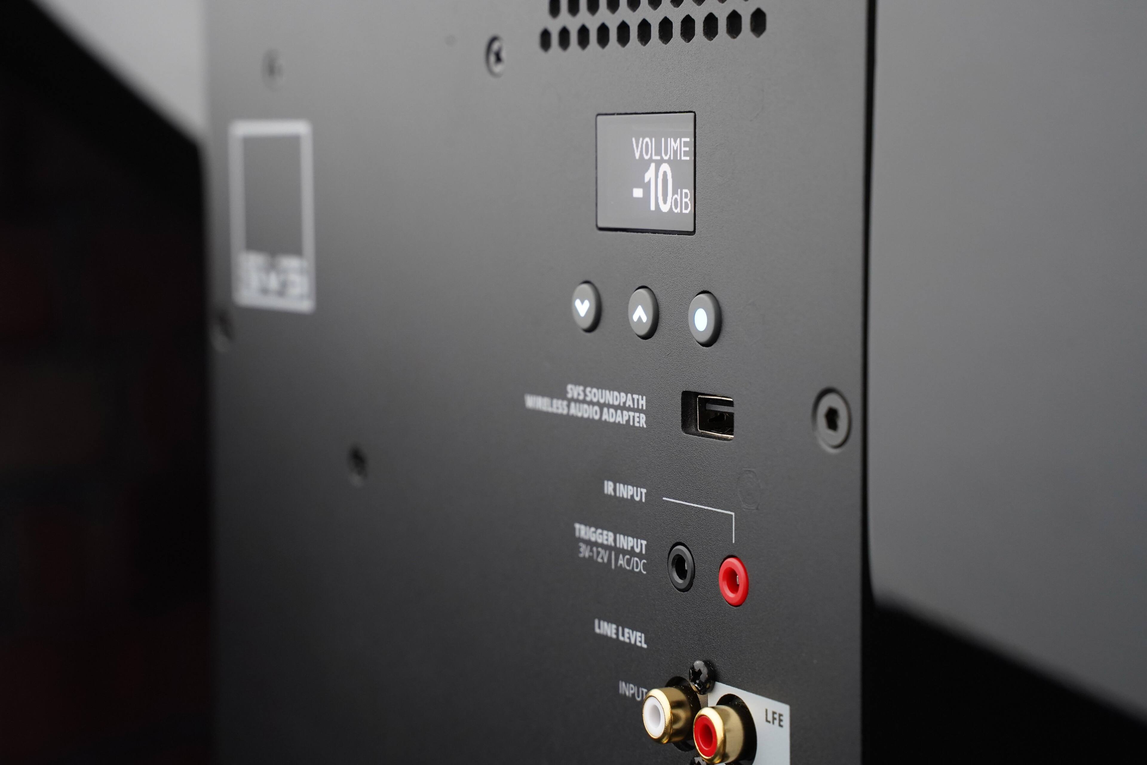 The text on the image reads: "Volume -10dB, SVS SoundPath Wireless Audio Adapter, IR Input, Trigger Input, 34-12V AC/DC Line Level Input, LFE."