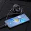 Bose is a brand of audio equipment, and the image shows a Bose speaker and a Bose headset. The headset is connected to the speaker, and the speaker is connected to a cell phone. The headset is placed on the speaker, and the cell phone is sitting on top of the headset.