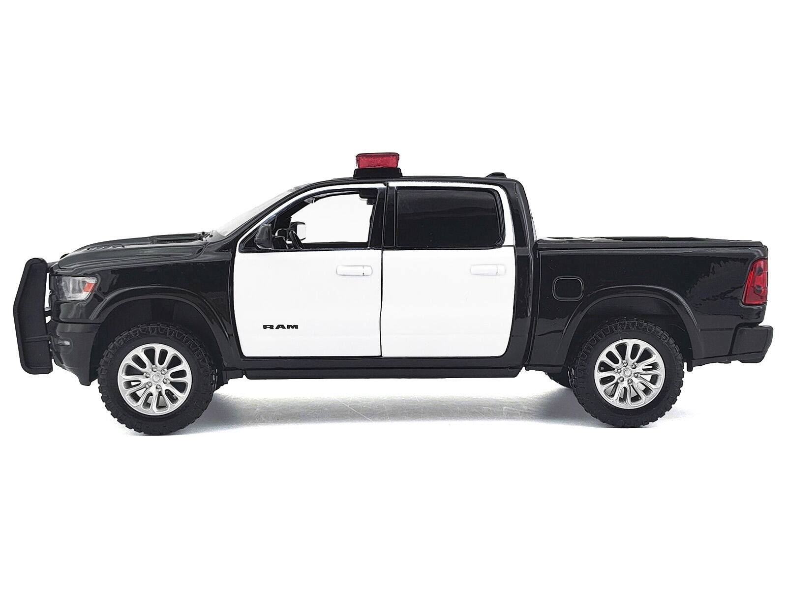 Alt View 2. Motormax - 2019 RAM 1500 Laramie Crew Cab Truck Black and White with Lights and Sounds 1/27 Diecast Model Car by Motormax.