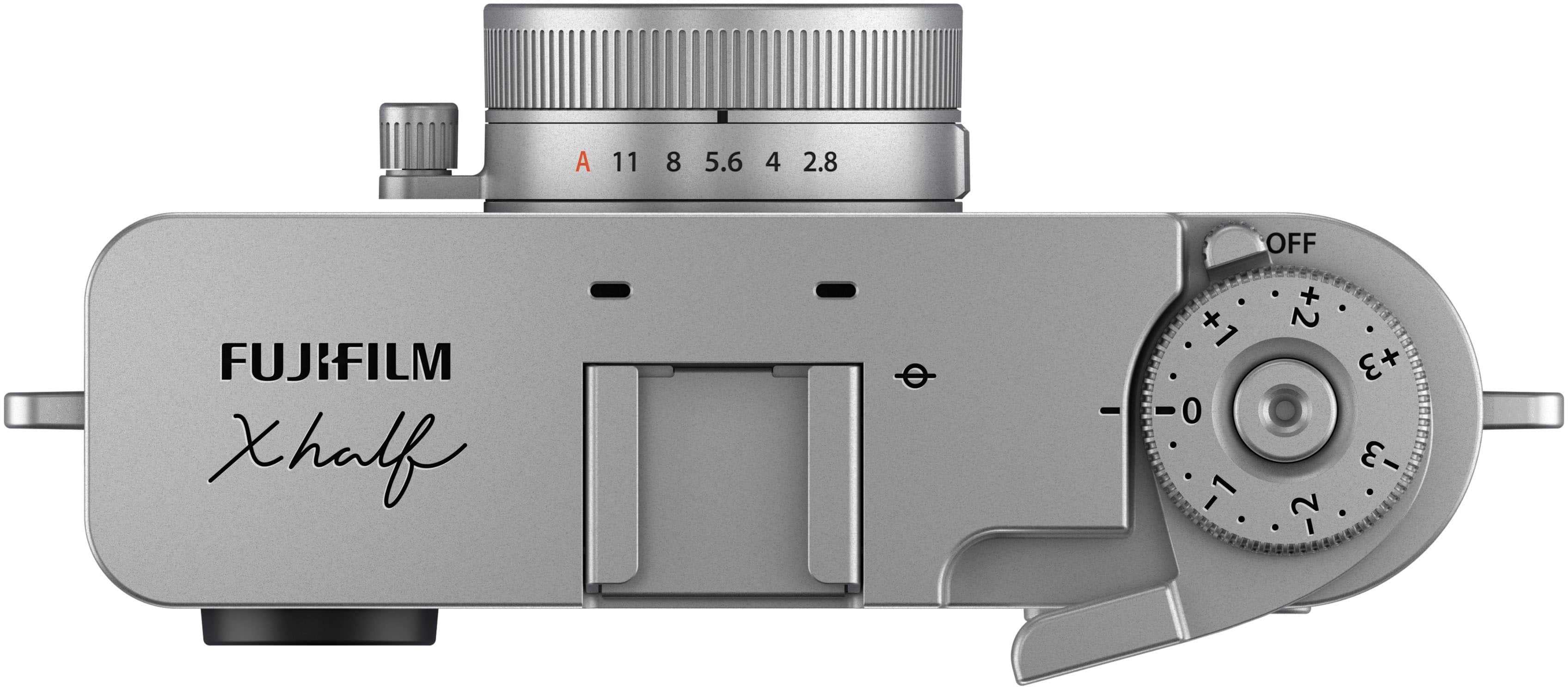 A FUJIFILM Xhalf camera with a lens attached. The camera has a range of settings, including 11, 8, 5.6, 4, 2.8, OFF, and aperture settings of +1, +2, +3, -1, -2, and -3.