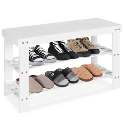 The image shows a white shelf with a variety of shoes on it. There are seven pairs of shoes in total, with some of them being black and white. The shoes are arranged in a neat and organized manner, making the shelf look tidy and visually appealing.