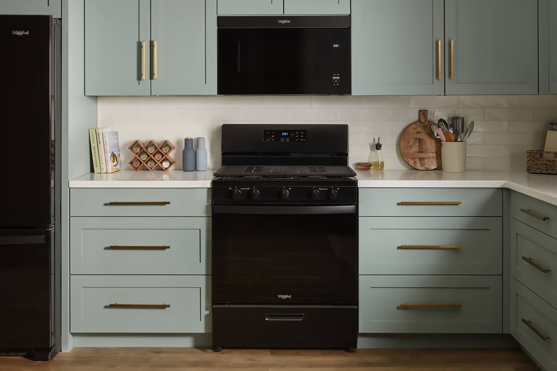 I'm sorry, but the text you provided does not make any sense and does not seem to be related to the image. The image shows a kitchen with a black stove, a microwave, and a refrigerator. It also features a counter with various items on it, including a knife set and a cat statue.