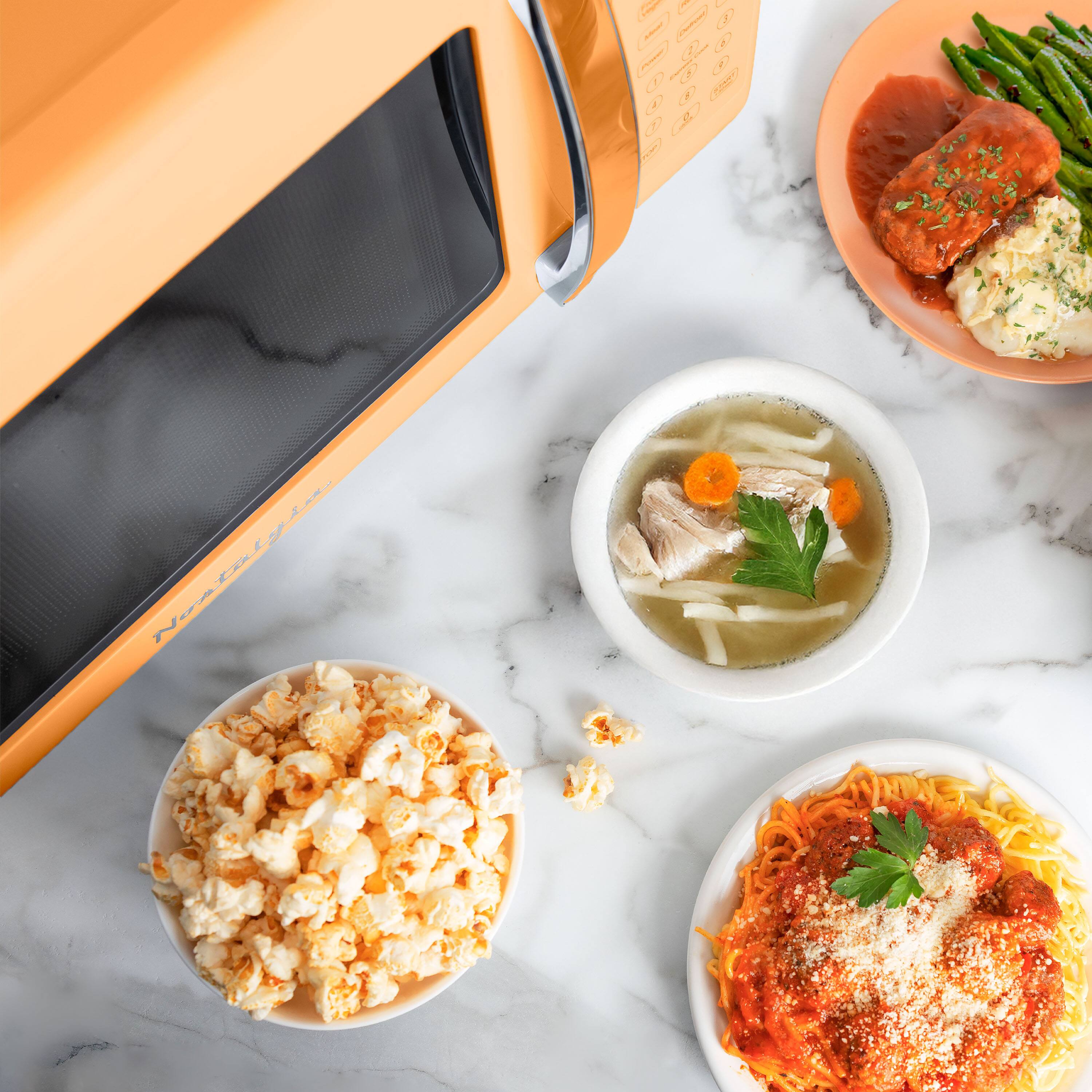 Left. Nostalgia - Retro 0.7 cu. ft. Countertop Microwave Oven - Orange - Orange.