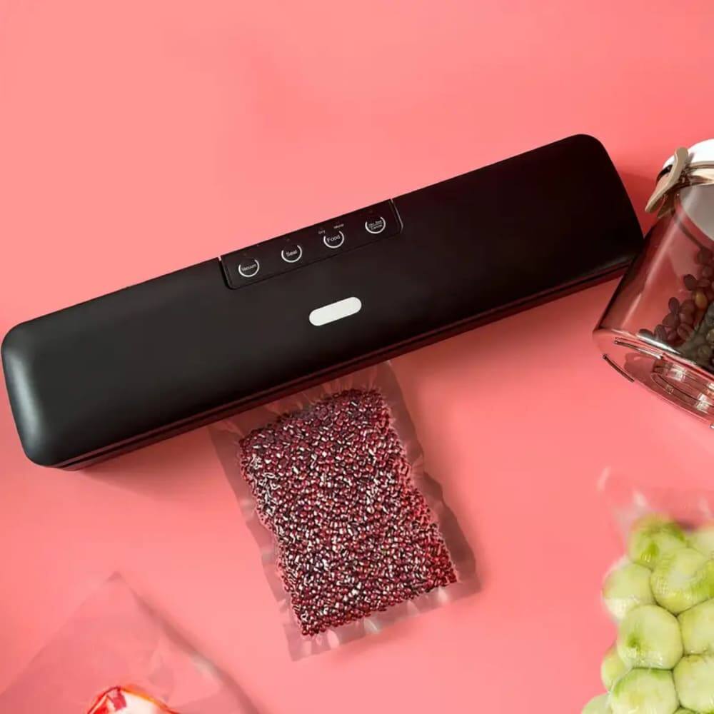 The image shows a black device with a few items around it, including a bag of red seeds and a jar of seeds. There is no seafood visible in the image.
Corrected text: Seeds