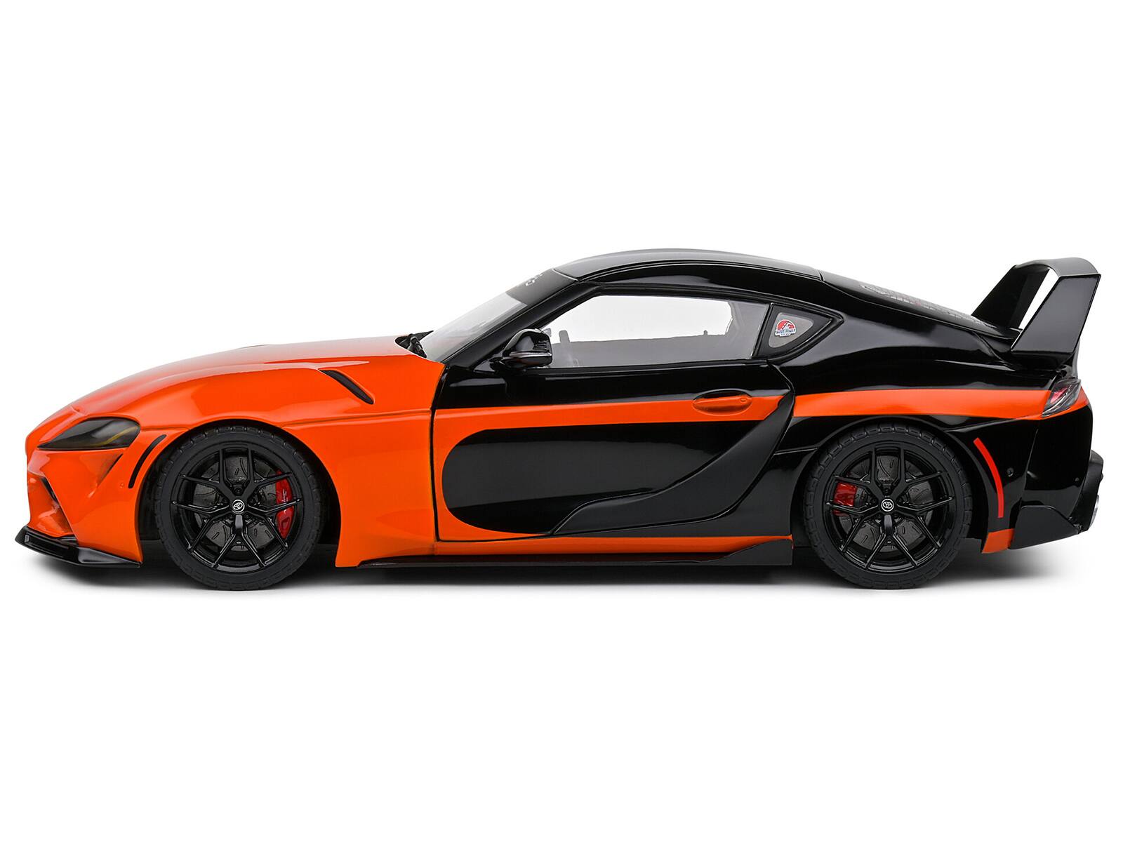 Left. Solido - 2024 Toyota GR Supra "StreetFighter" Orange and Black 1/18 Diecast Model Car by Solido - Orange and Black.