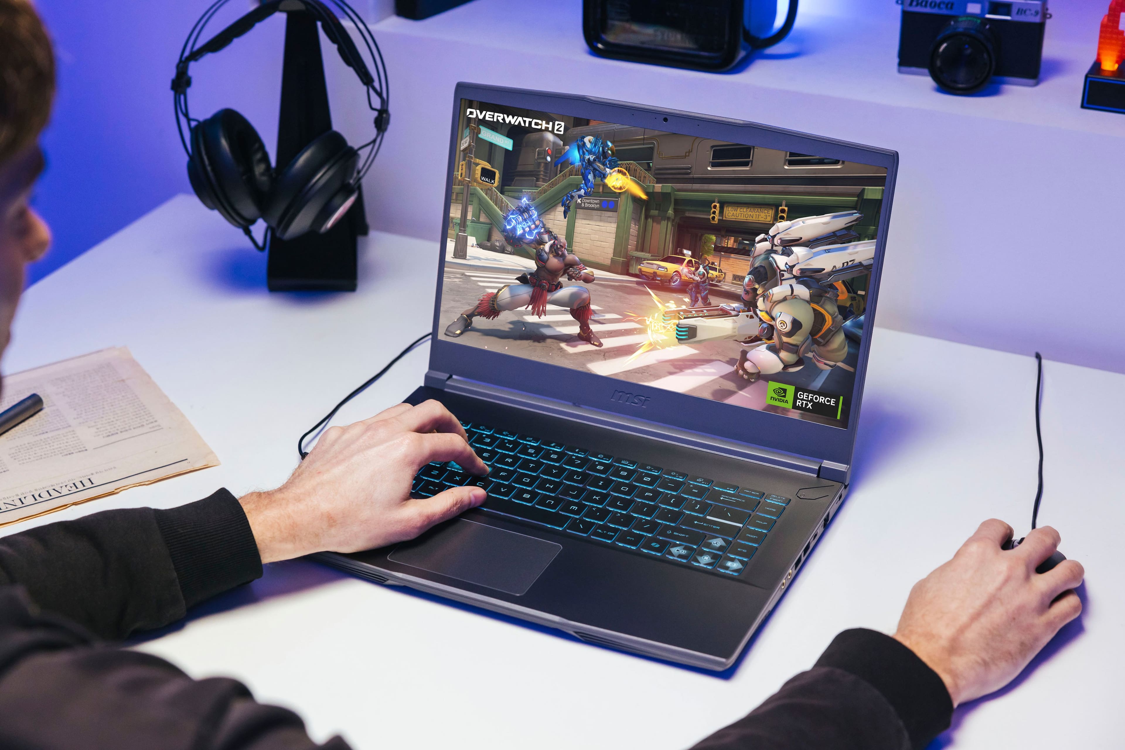 The text on the image reads: "C uoca BC.9 OVERWATCH 2 SRAND - ia - 1 10 718L O NI-2 mst TA RTX GEFORCE HEADLIN 2 - - - - - N - - - - - - - T a0 - * - - - P - - L 7 - - - - - . - . - a - . - 7 I . - 5 - . - - - I - - - - 2 . a - - : T - - 1 : - d : - : I :".