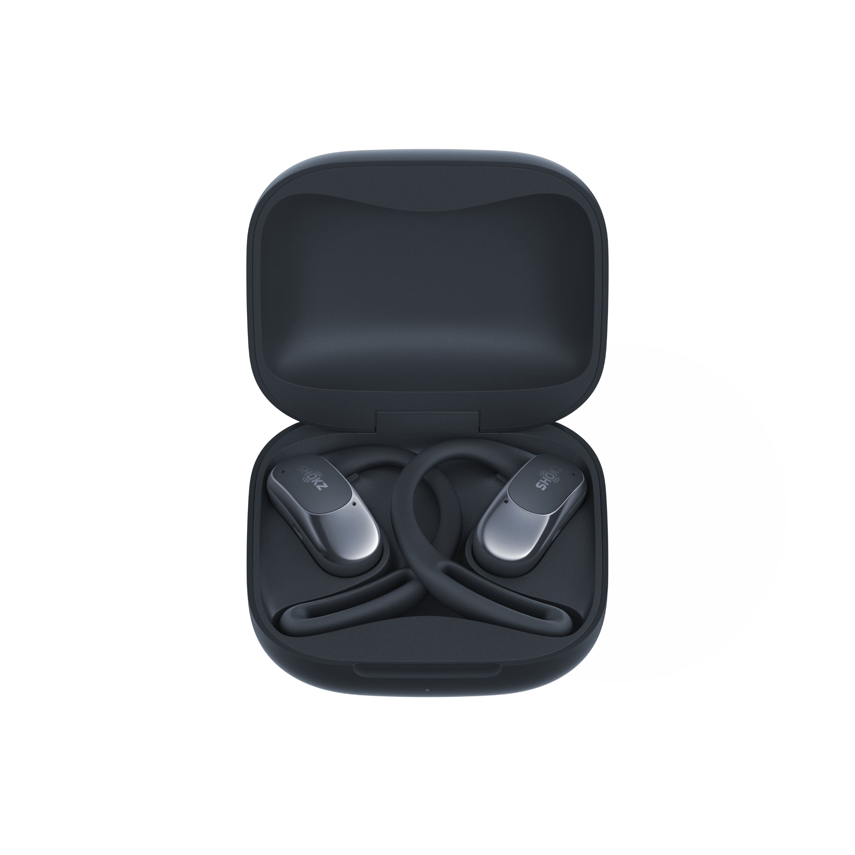 The image features a pair of black earbuds in a black case. The earbuds are designed by Shokz, and they are placed inside the case, which is open and ready to be used. The case is made of a hard plastic material, providing protection and storage for the earbuds. The earbuds are positioned in the case, with one earbud on the left side and the other on the right side.
