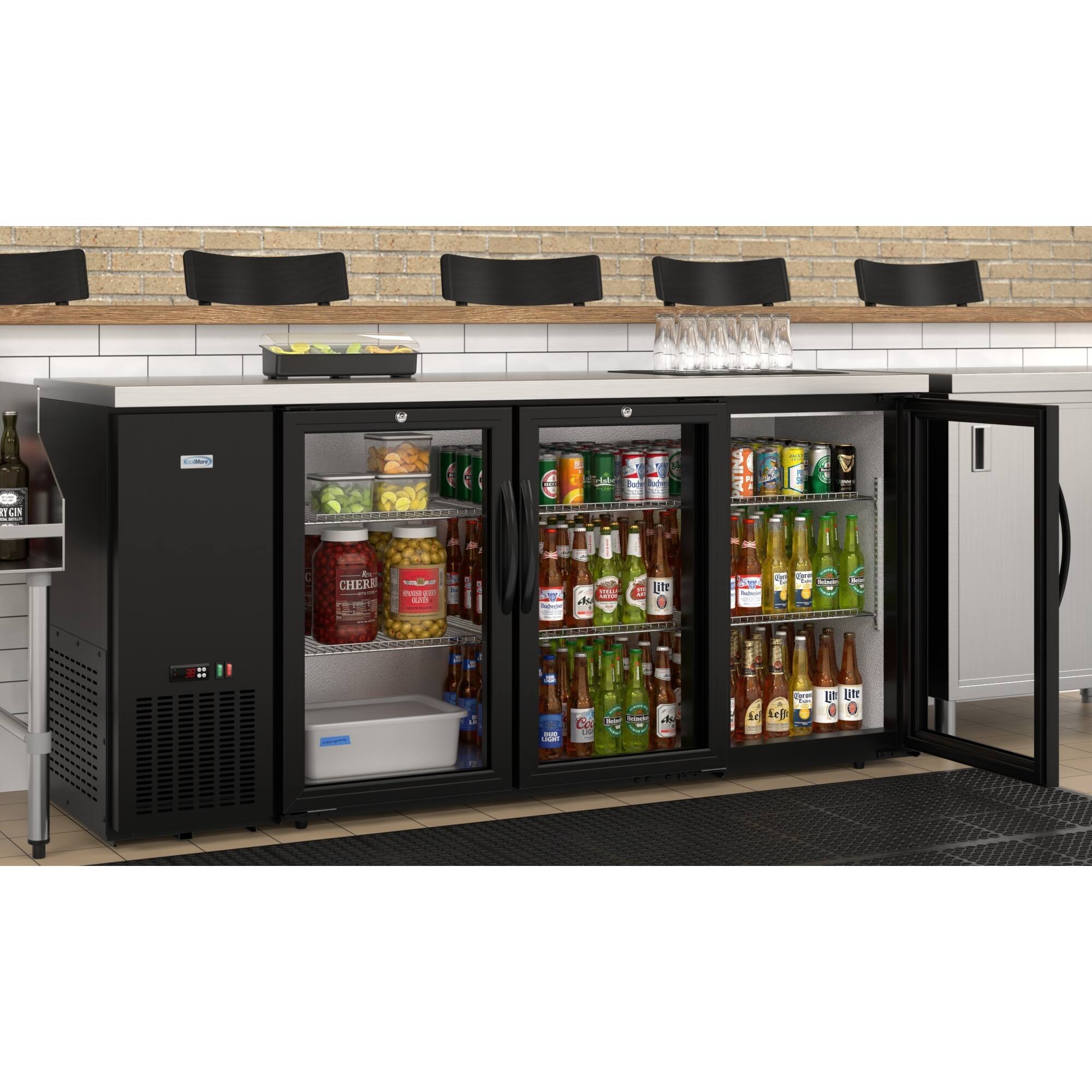 The image features a refrigerator filled with various beverages, including beer and soda. The refrigerator is located in a kitchen area, and there are several chairs placed around it. The refrigerator is stocked with a wide variety of drinks, making it an ideal place to store and serve refreshments.