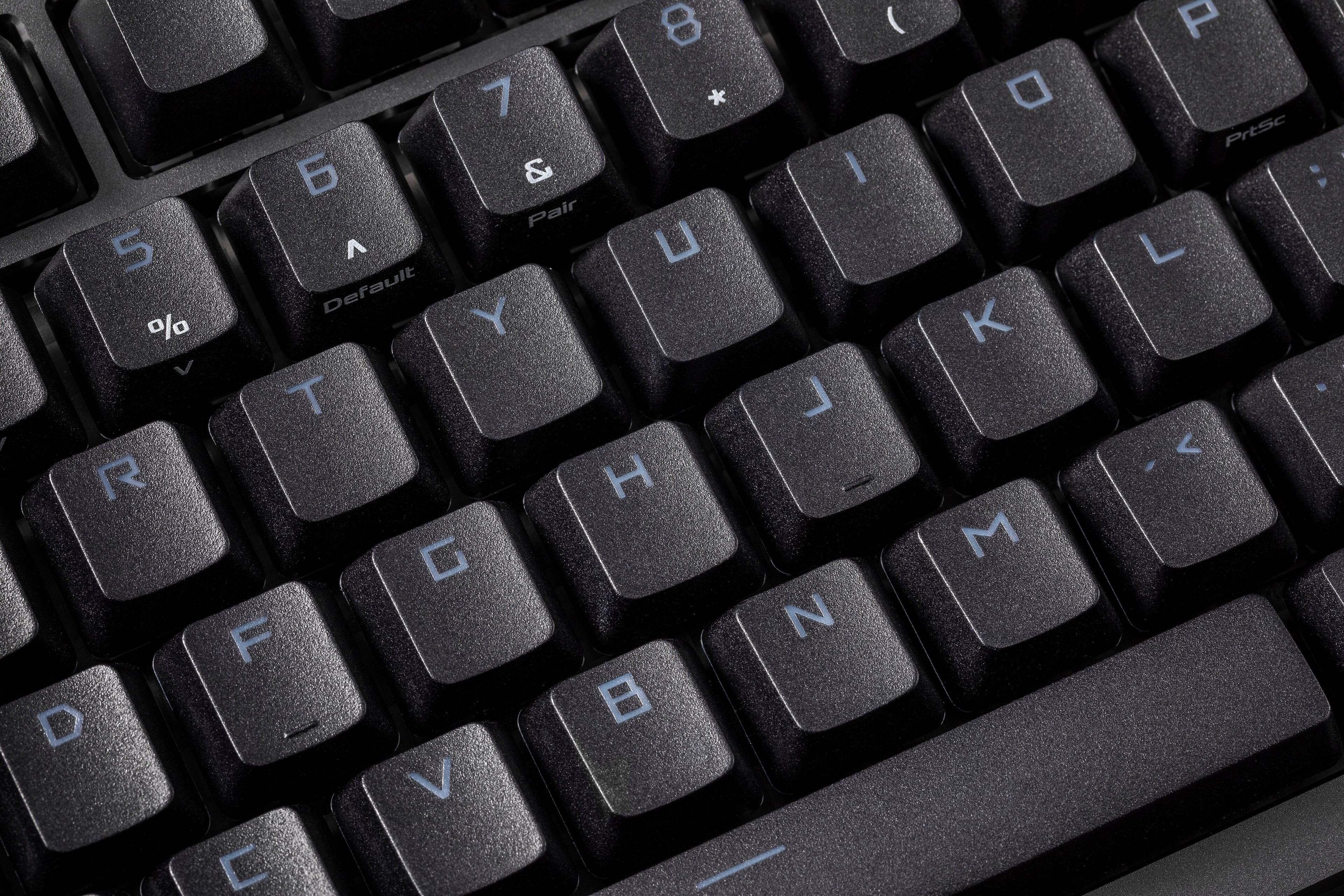 The image shows a close-up of a black keyboard with the letters A, S, D, F, G, H, J, K, L, M, N, O, P, Q, R, S, T, U, V, W, X, Y, and Z visible. The keyboard also has the numbers 1, 2, 3, 4, 5, 6, 7, 8, 9, 0, and the arrow keys. The keys are arranged in a standard layout, with the letters and numbers occupying the majority of the space.
