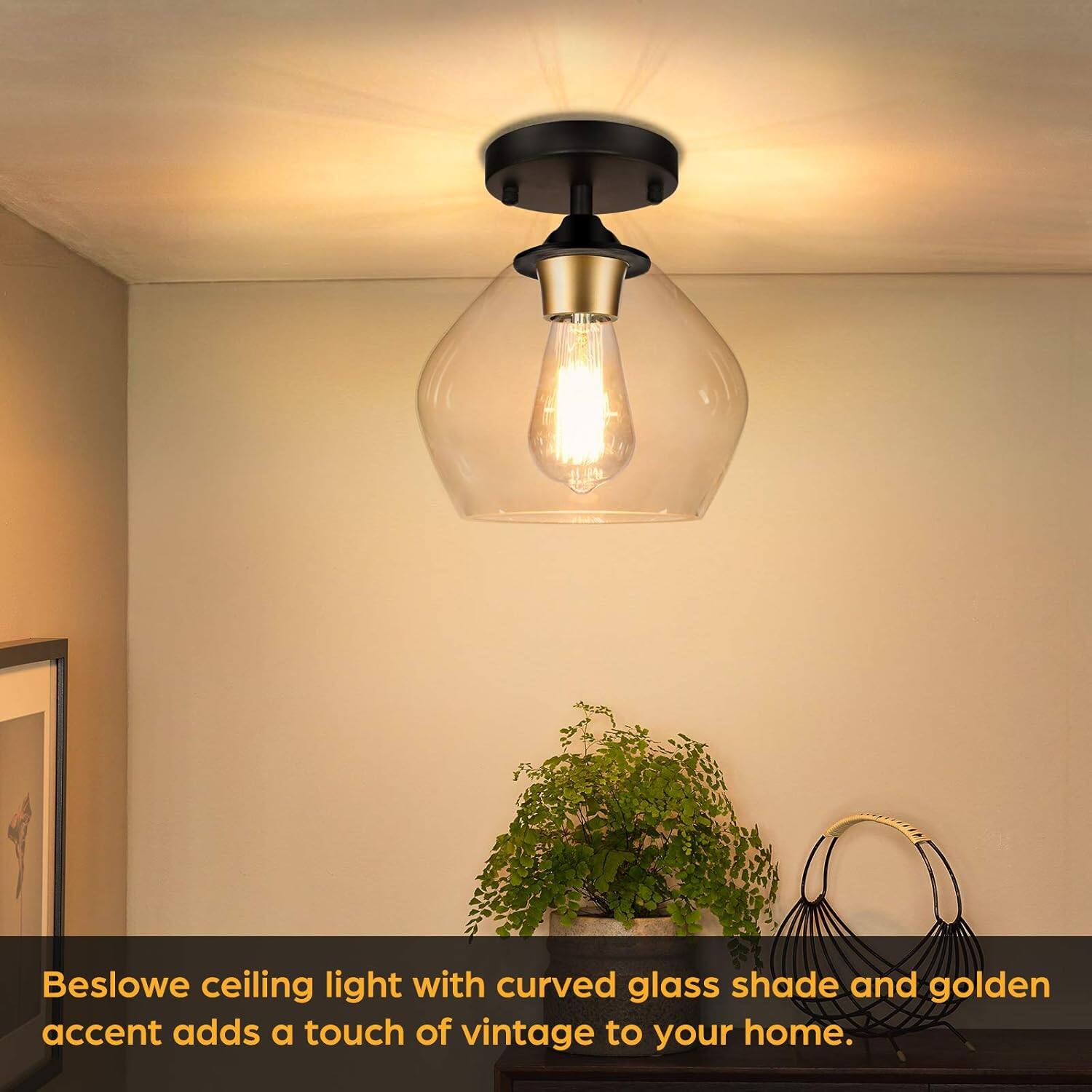 Beslowe ceiling light with curved glass shade and golden accent adds a touch of vintage to your home.