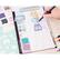 The image shows a person drawing a girl's figure in a notebook. The person is using a pencil and a ruler to create the drawing. The notebook is open to a page with a color palette, which includes various colors such as blue, green, purple, pink, and orange. The person is likely using these colors to create a detailed and accurate representation of the girl's figure.