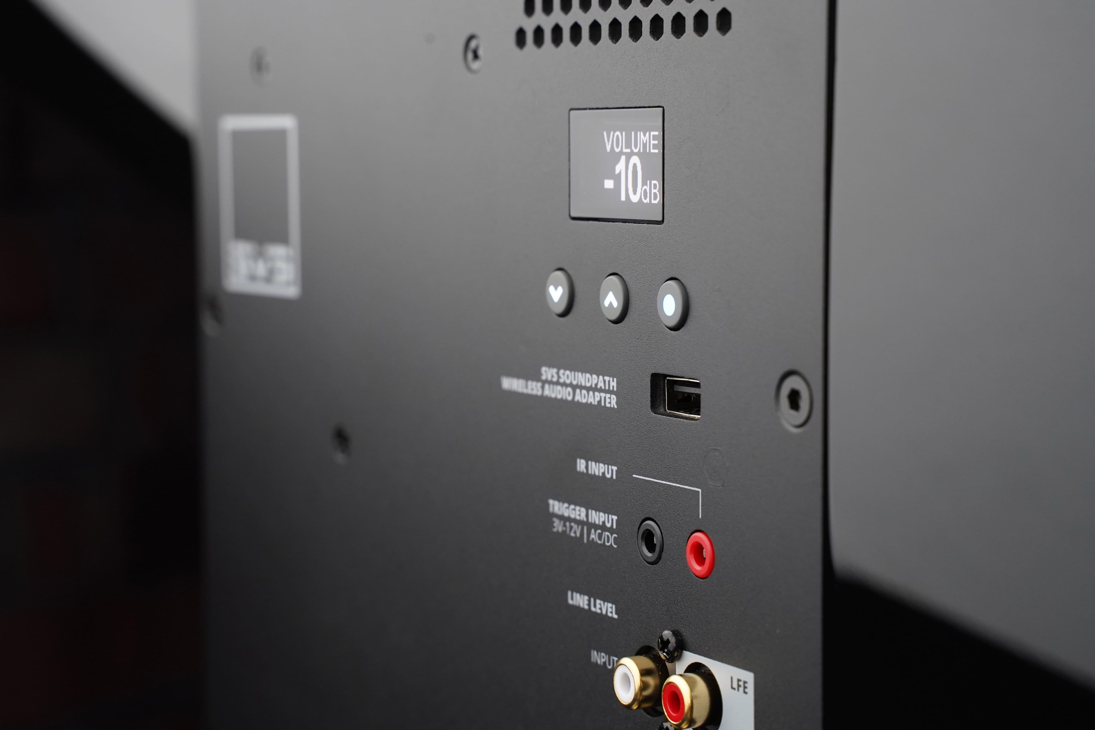 The text on the image reads: "Volume -10dB, SVS SoundPath Wireless Audio Adapter, IR Input, Trigger Input, 34-12V AC/DC Line Level Input, LFE."