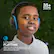 The image features a young boy wearing headphones and smiling. The headphones are described as having a 35+ hours battery life, offering wireless playtime to listen to music or watch a movie via Bluetooth 5. The headphones can be recharged using the included USB cable.