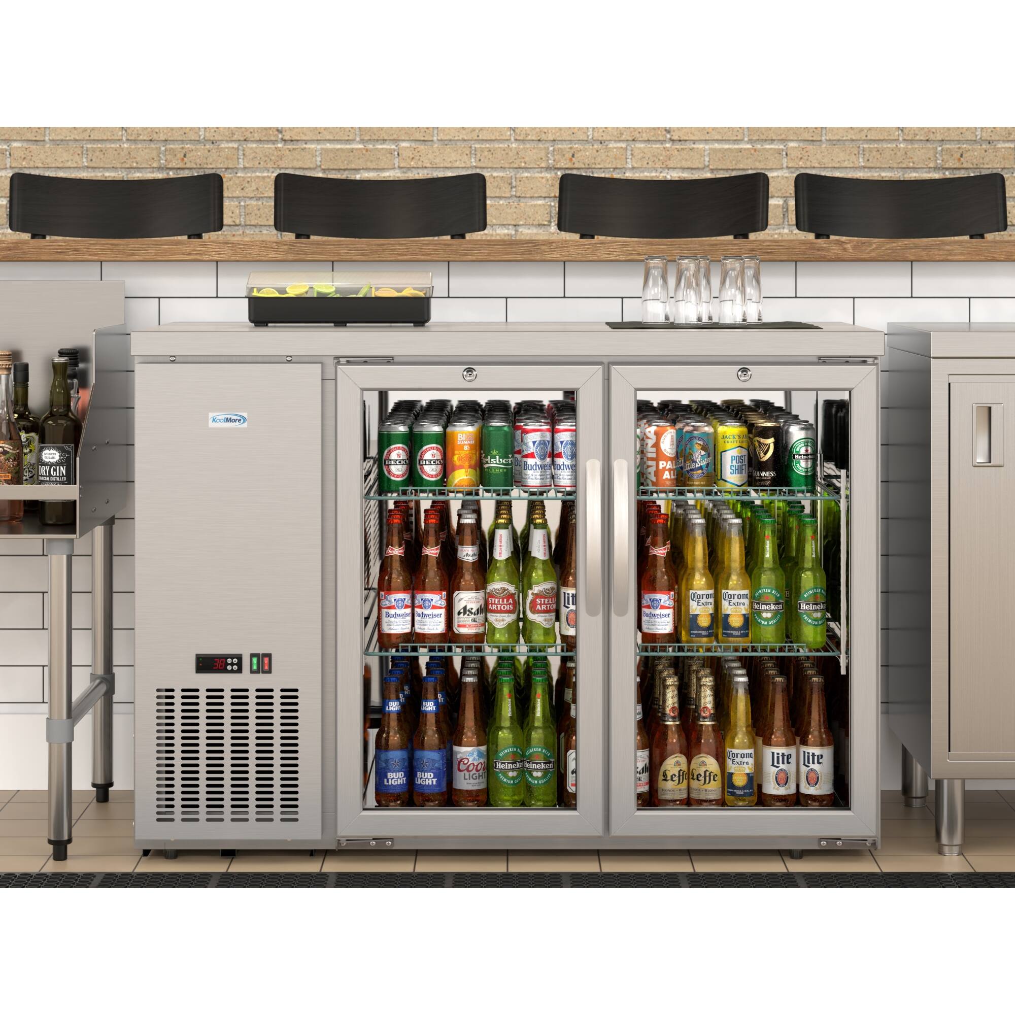 The image shows a refrigerator filled with a variety of beer bottles. There are at least 12 different types of beer visible, with some bottles placed in the middle and others towards the top and bottom of the refrigerator. The refrigerator is located in a room with a brick wall, and there are chairs placed around the area. The scene suggests a social gathering or a bar setting where people can enjoy a selection of beers.