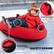 The text on the image is grouped as follows:
1. Gripping Handles: Safer and easier to control sliding directions.
2. Hook and Loop Fastener: Fixation for tying legs.
3. Safety Design: The image showcases a child wearing a red coat and sitting on a red sled, which is designed with safety in mind.
