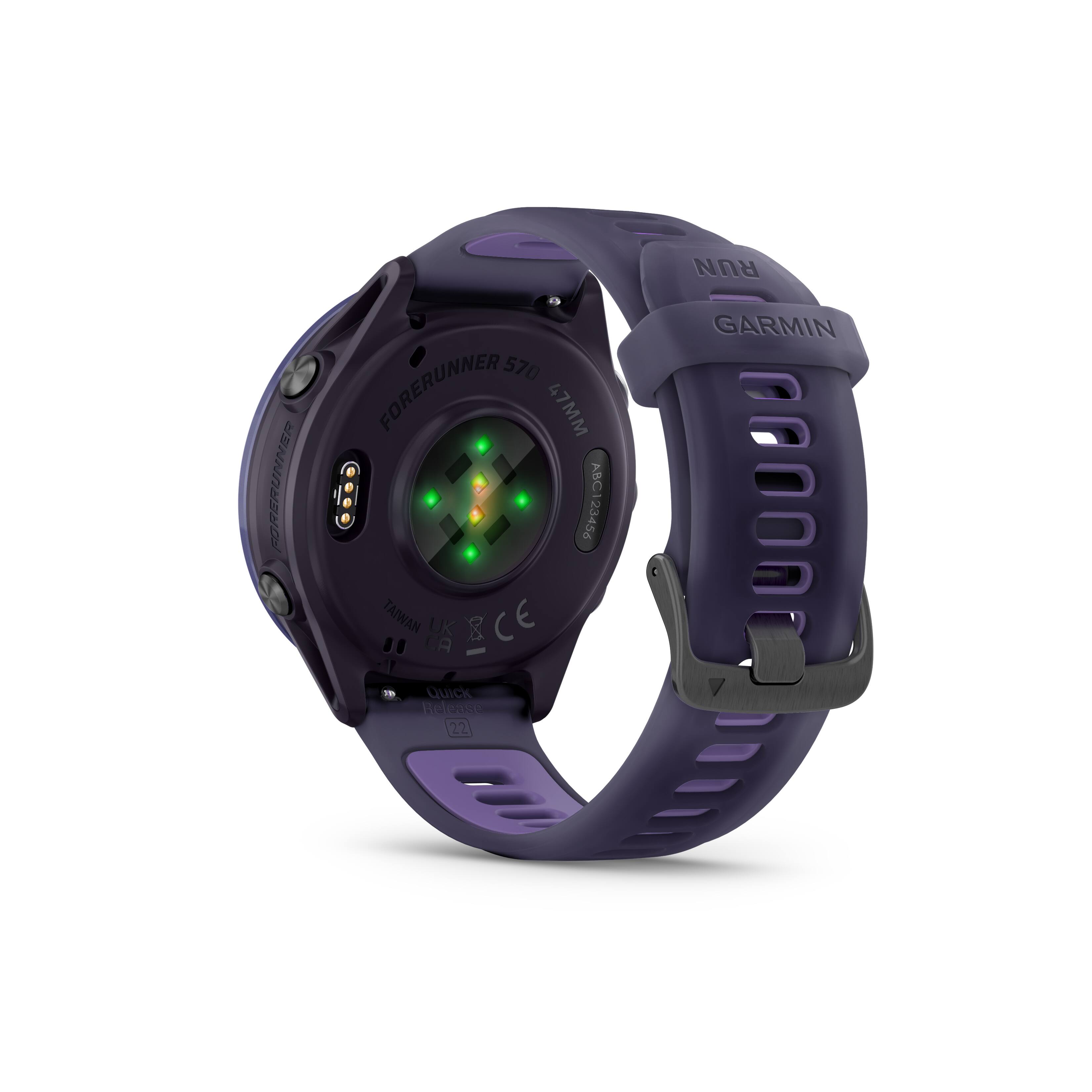 The image features a Garmin watch with a purple and black color scheme. The watch has a green light on the face, which indicates that it is a Forerunner 570. The watch is designed for runners and has a quick release feature. The watch is made in Taiwan and is certified by the UK and CE.