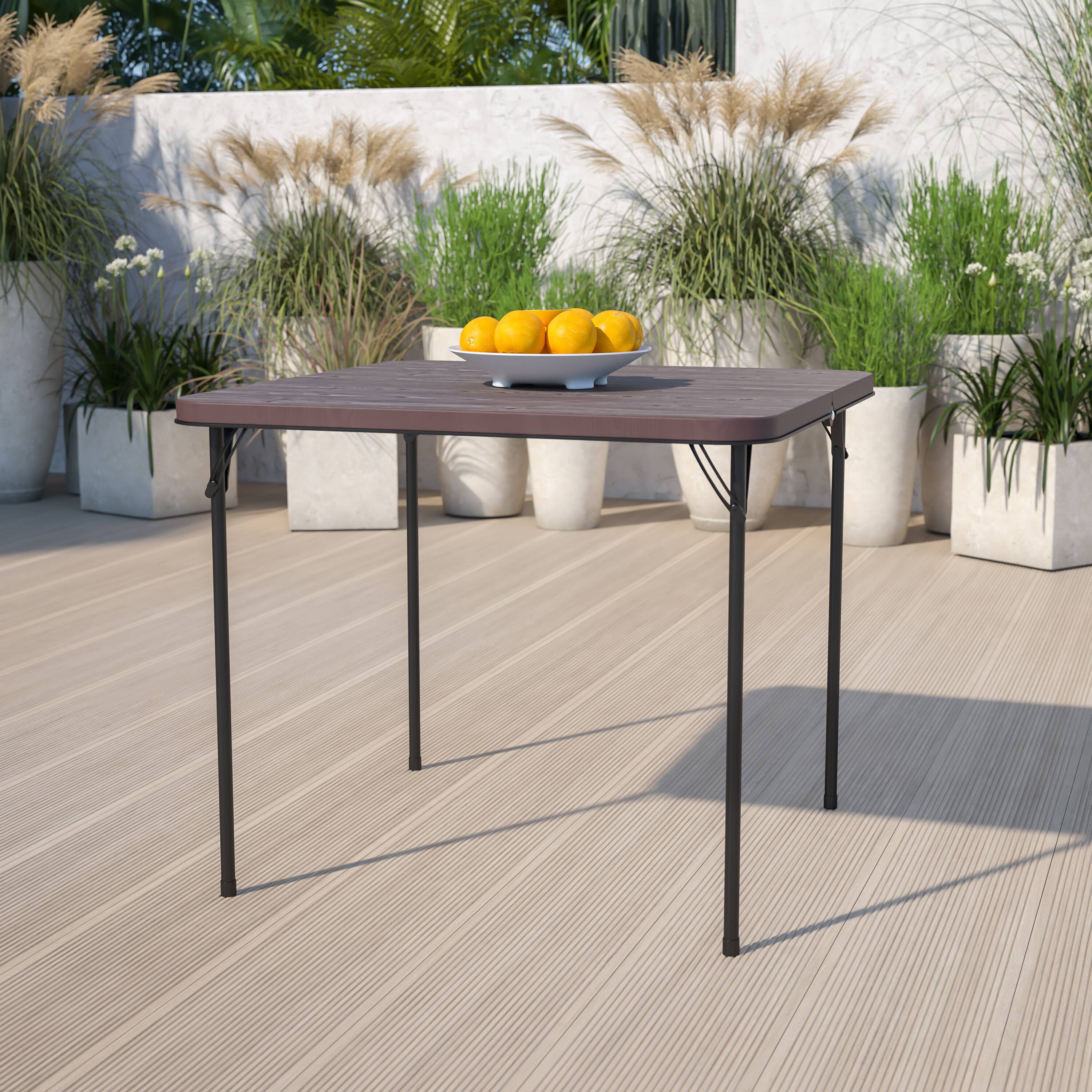 Alt View 1. Emma + Oliver - 2.83-Foot Square Bi-Fold Plastic Folding Table with Carrying Handle - Brown.