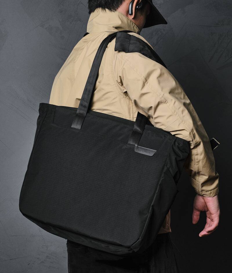 Angle. ALPAKA - Metro Tote Laptop Tote Bag for Work, Work Tote Fits 16" MacBook Pro, Side Bottle Pocket, Weather-Resistant, Key Tether - Black Axoflux 210D.