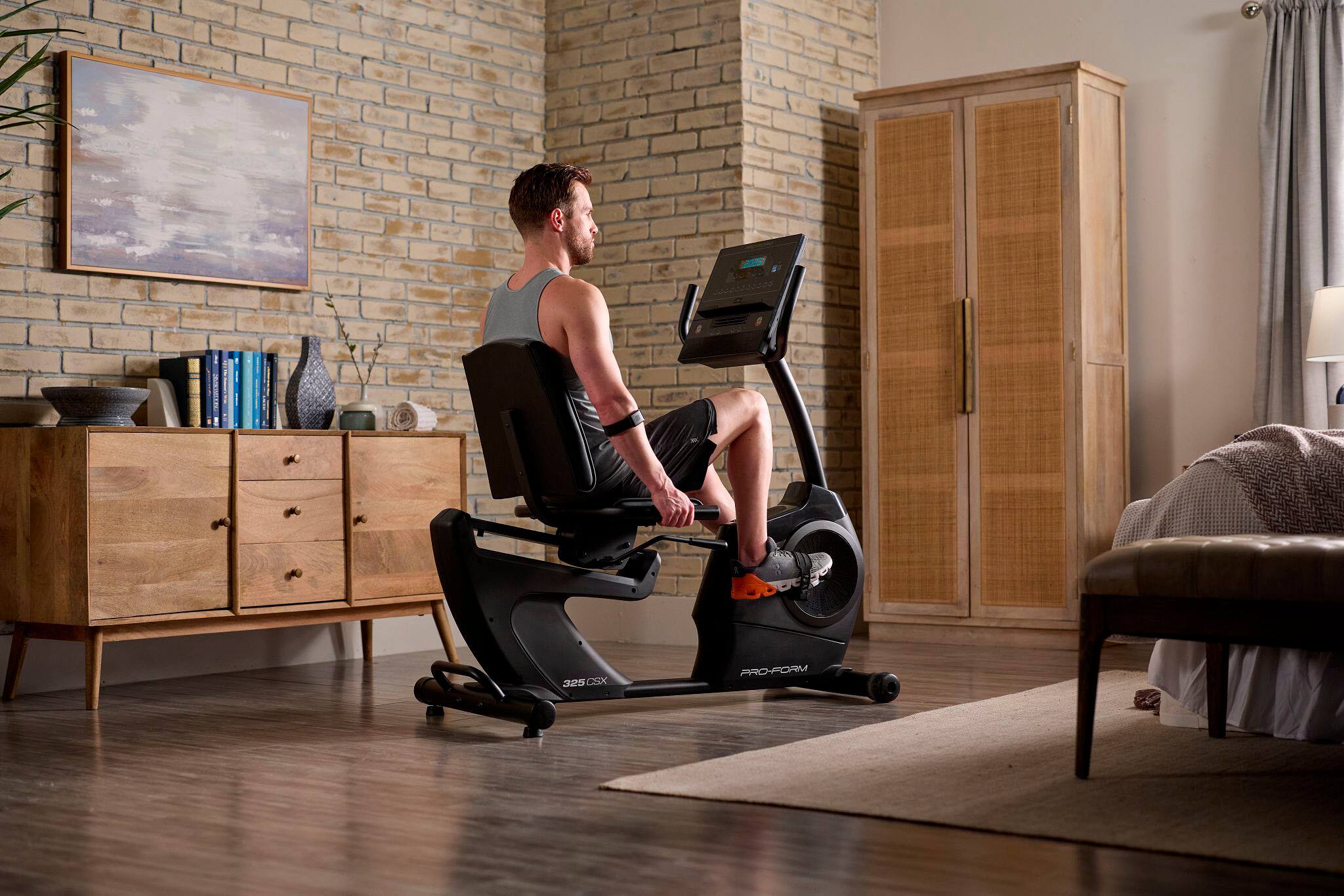 The man is using a Pro-Form CSX 325 exercise machine.