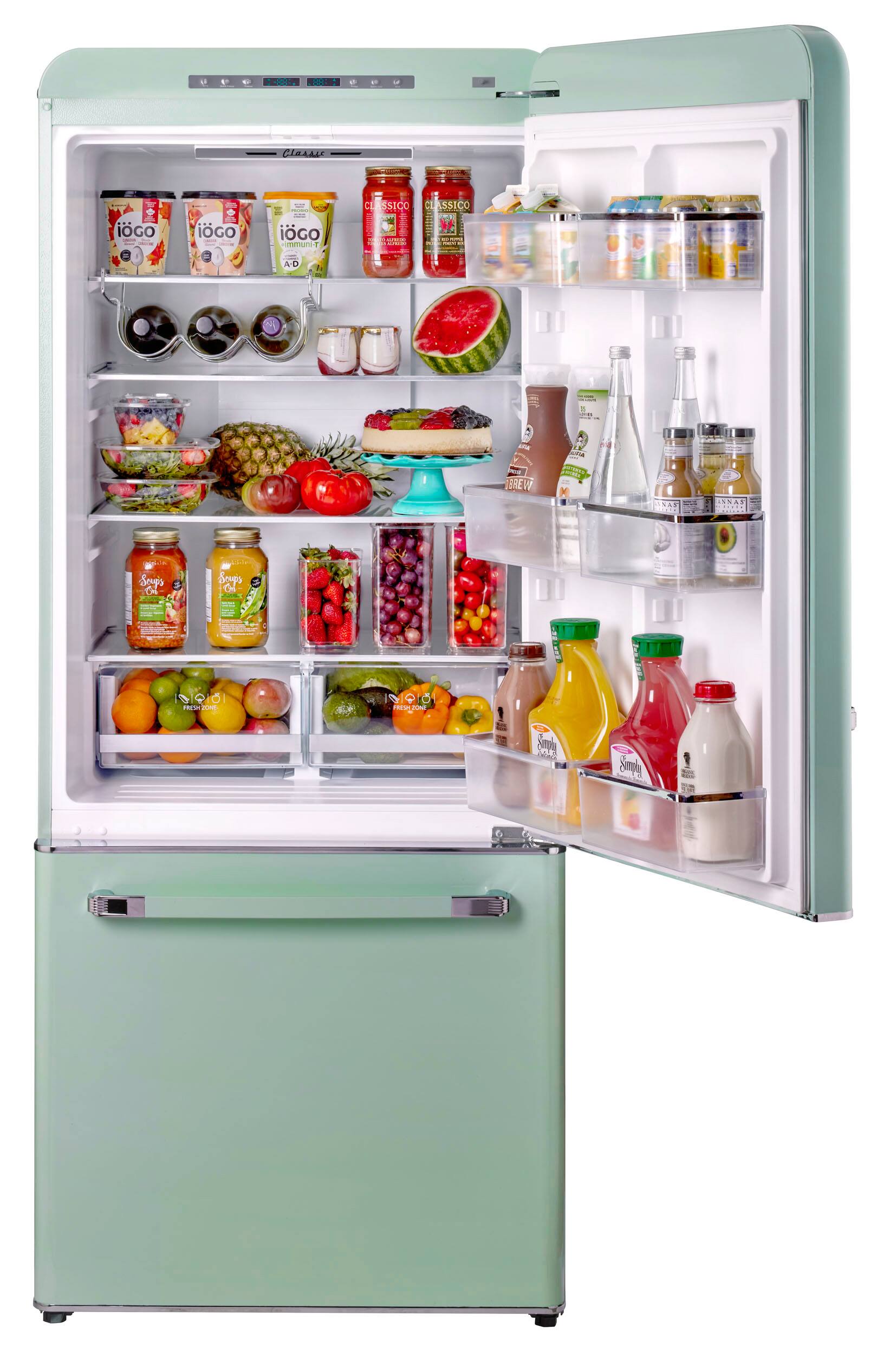 A refrigerator is open, revealing a variety of food items inside. There are several bottles, including a bottle of orange juice, and a bowl of fruit. The refrigerator also contains a variety of other food items, such as apples, oranges, and broccoli. The refrigerator is filled with a diverse assortment of items, making it a well-stocked and convenient place to store food.