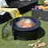 "LKI WR YOUTH UTIFUL" is a phrase that does not make sense in the context of the image. The image shows a backyard scene with a fire pit, a grill, and a table with various items on it. There are no visible signs or text that could be grouped or corrected based on the given phrase.