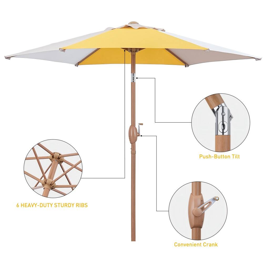 The image shows a yellow umbrella with a wooden handle and a push-button tilt. The umbrella has six heavy-duty sturdy ribs, making it a durable and reliable option for protection from the elements. The wooden handle adds a touch of elegance and sophistication to the umbrella, making it a stylish accessory. The push-button tilt allows for easy adjustment of the umbrella's angle, providing added convenience for the user.