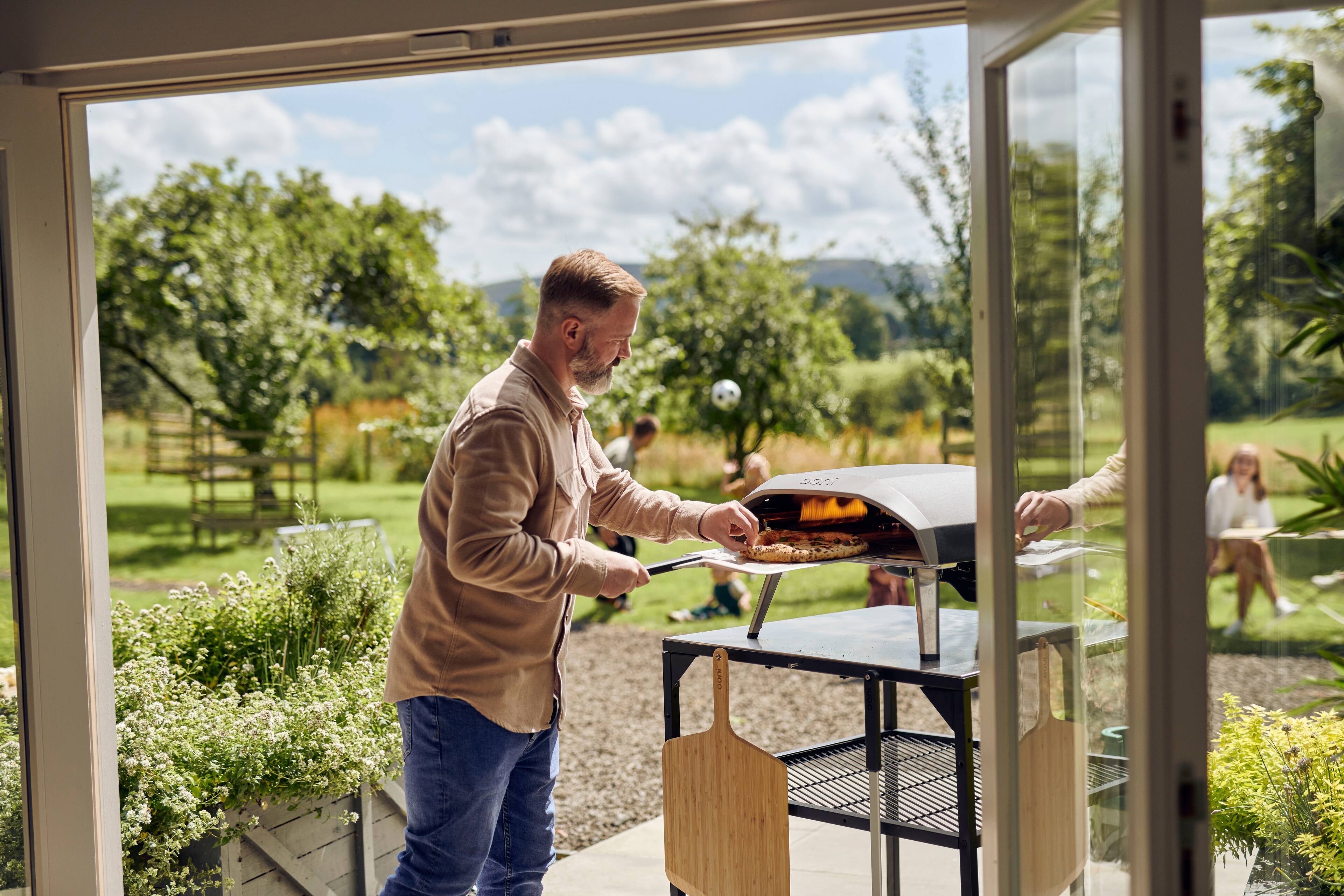The man is cooking food on a grill.