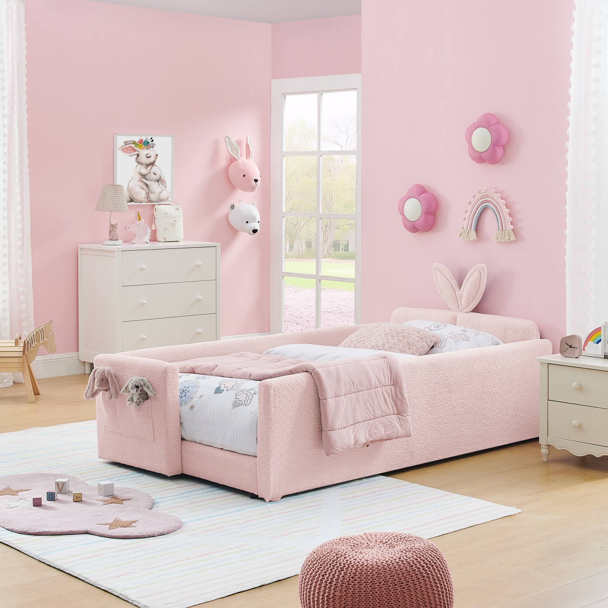 Angle. GOODSILO - Twin Size Upholstered Platform Bed with Playful Bunny Ear Headboard and Safety Features in Soft Neutral Fabric - Pink.