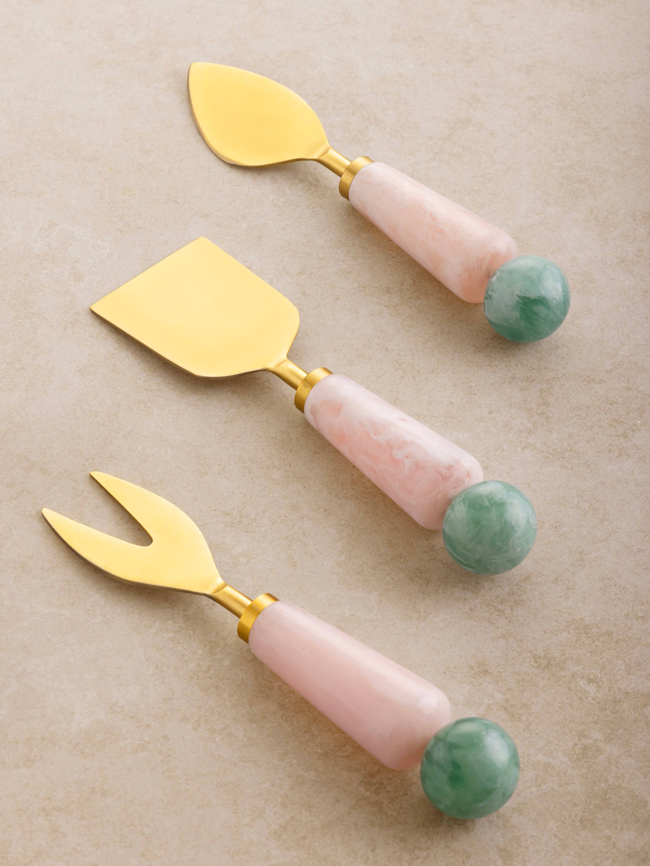 Angle. GAURI KOHLI - Copenhagen Cheese Knives - Shades of pink, green and gold.