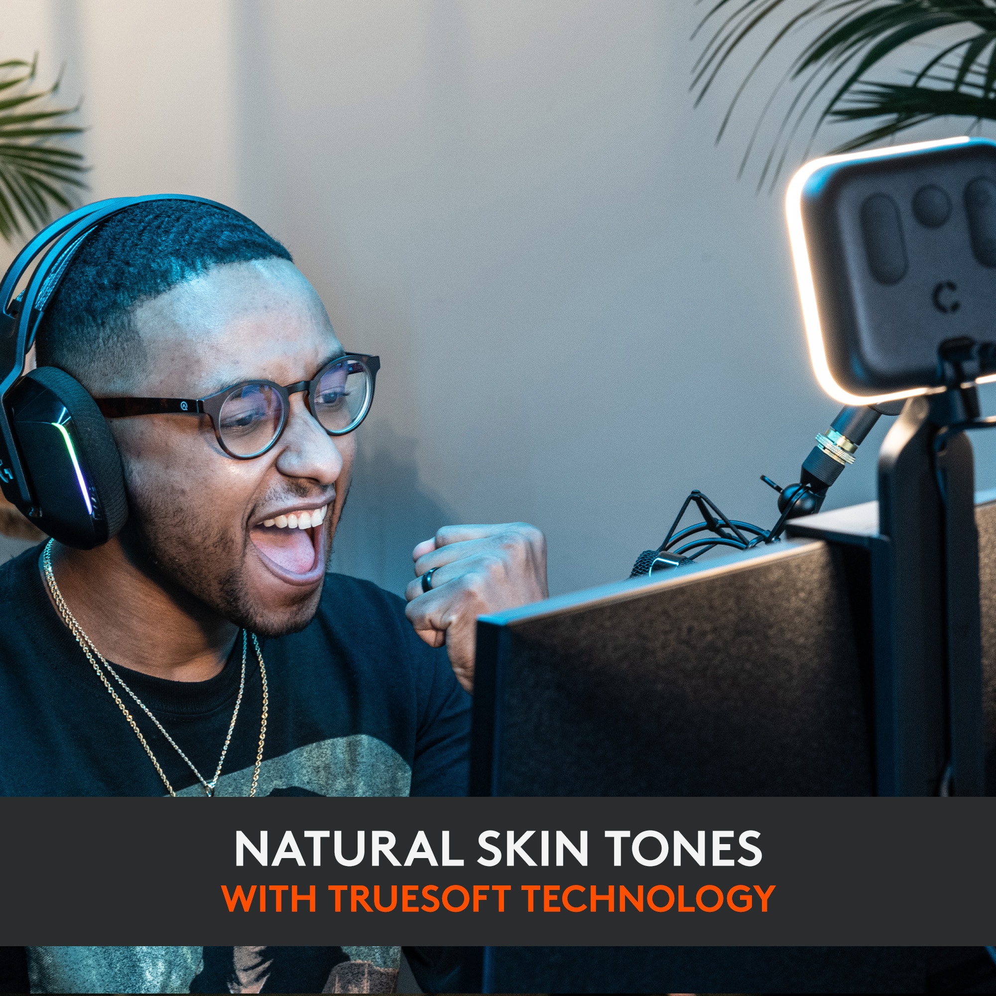 I am smiling and wearing headphones while using a computer. The image suggests that I am enjoying my time using the computer, possibly playing a game or listening to music. The headphones and the computer screen are the main focus of the image, and the man's smile indicates a positive experience.