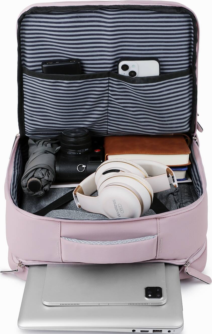 The image shows a pink suitcase with various items inside, including a laptop, a cell phone, a book, a pair of headphones, and a camera. The suitcase is open, revealing the contents. The laptop is placed on top of the suitcase, while the cell phone is located near the center of the suitcase. The book is placed towards the right side of the suitcase, and the headphones are positioned towards the left side. The camera is located in the middle of the suitcase, surrounded by the other items.