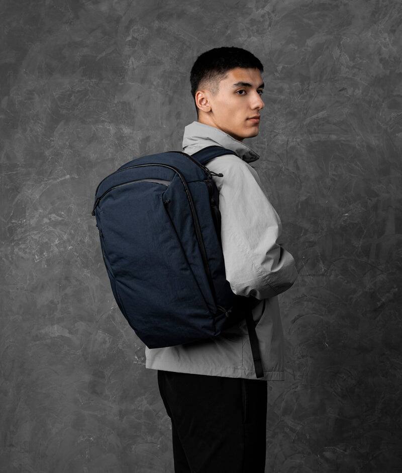 Angle. ALPAKA - Traverse Backpack Laptop Backpack for Men, Backpack with Laptop Compartment (16"), Clamshell Travel Pack, Bottle Sleeve - Moonlight Blue Axoflux 400D Ripstop Nylon.