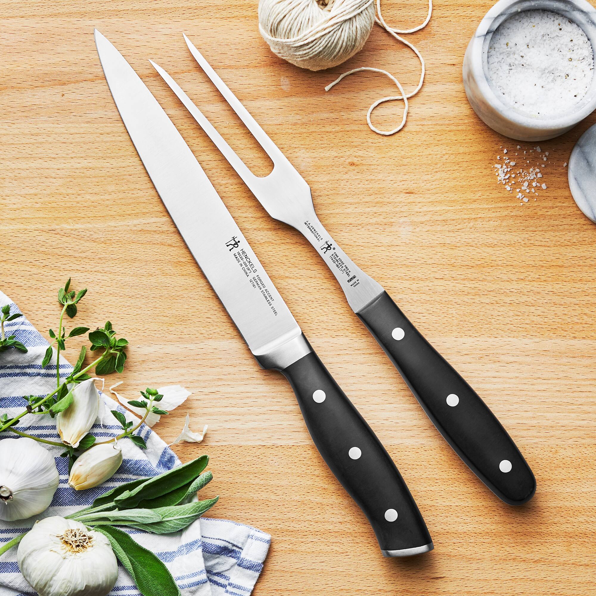 The text on the knives reads:

"J.A. HENCKELS
NEW YORK
GERMANY
MADE IN CHINA"