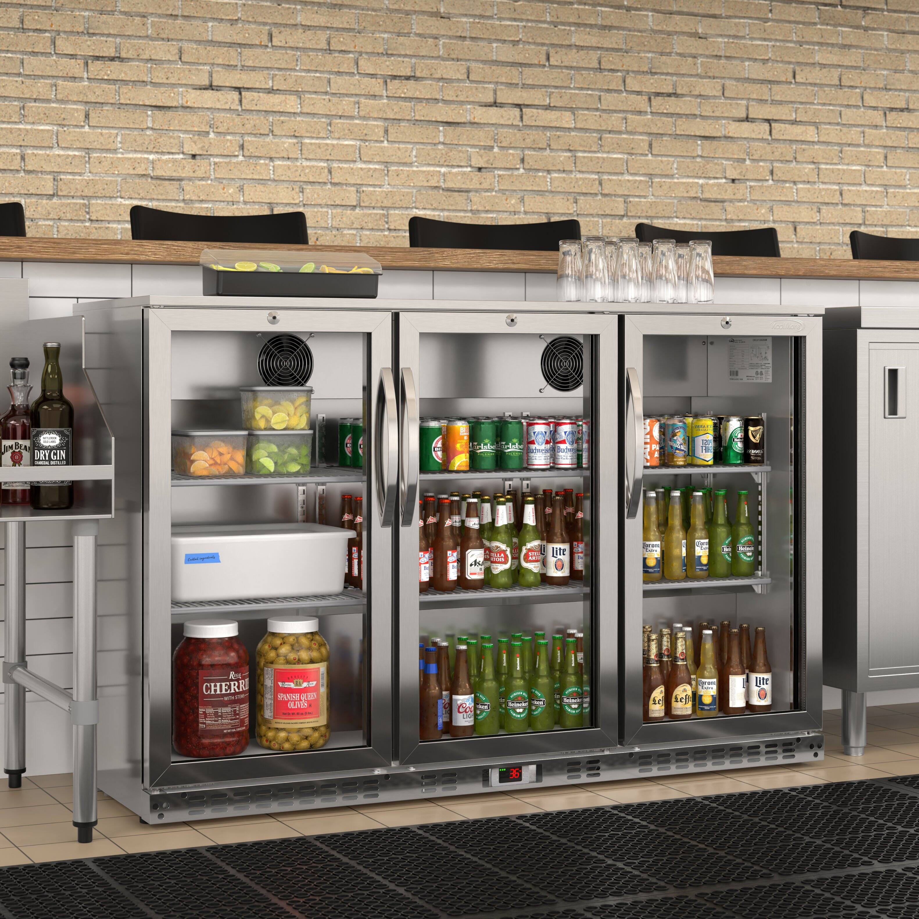 Sure, here is the corrected and grouped text from the image:

---

**Top Shelf:**
- Lindbergh DRY GIN

**Middle Shelf (Left):**
- CHERRIES
- SPANISH GREEN OLIVES

**Middle Shelf (Right):**
- Various canned drinks (e.g., Coca-Cola, Sprite, Fanta, etc.)

**Bottom Shelf (Left):**
- Various bottled drinks (e.g., Heineken, Corona, etc.)

**Bottom Shelf (Right):**
- More bottled drinks (e.g., Heineken, Corona, etc.)

**Temperature Display:**
- 36°F

---