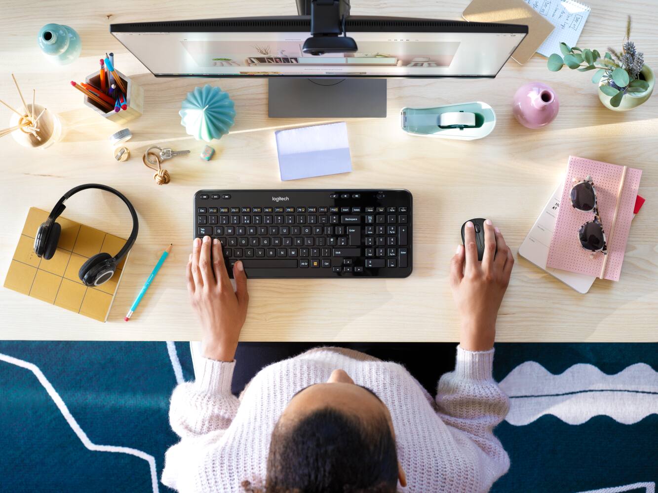 The laptop is a Logitech model.